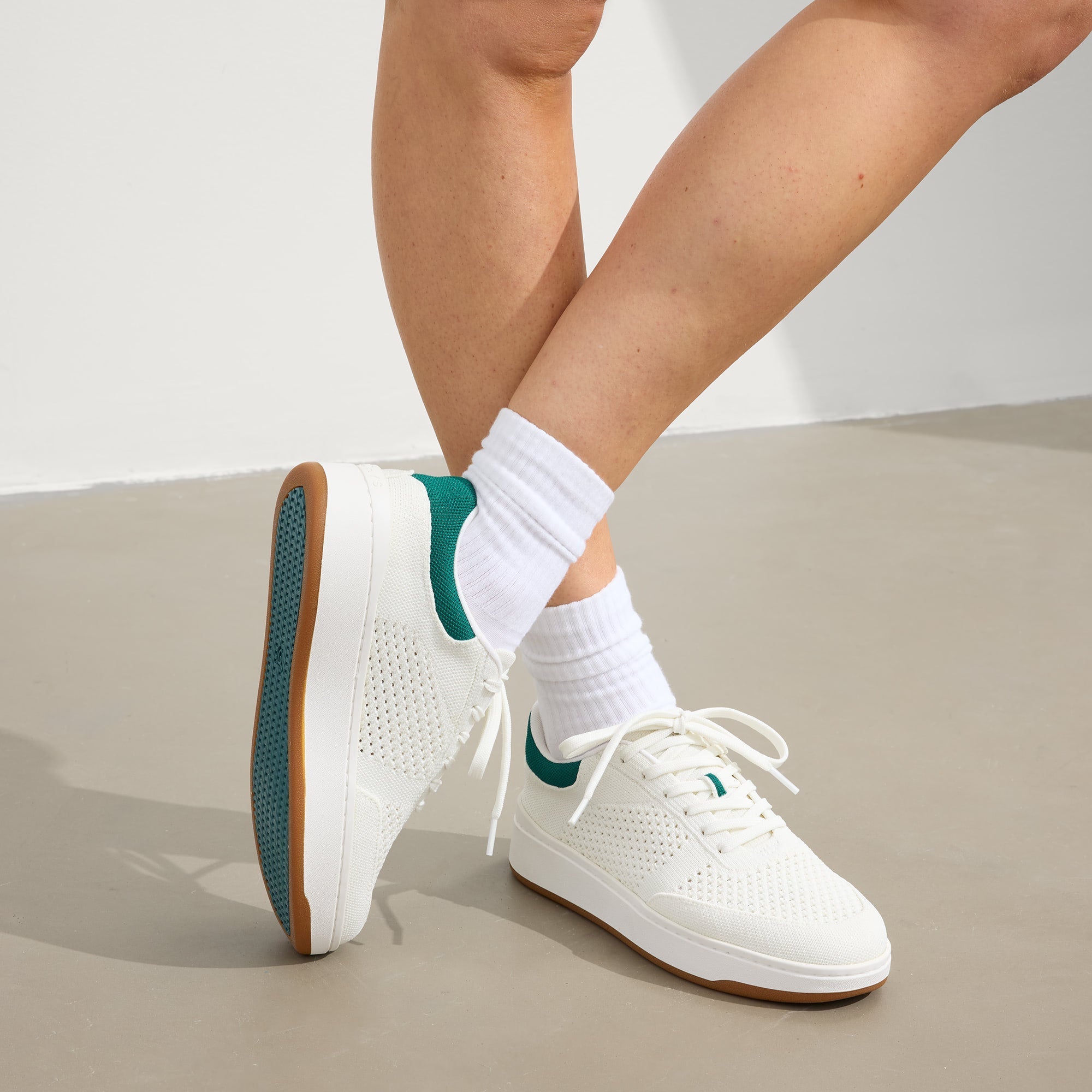 hover | Model wearing The Court Sneaker in Birdie.