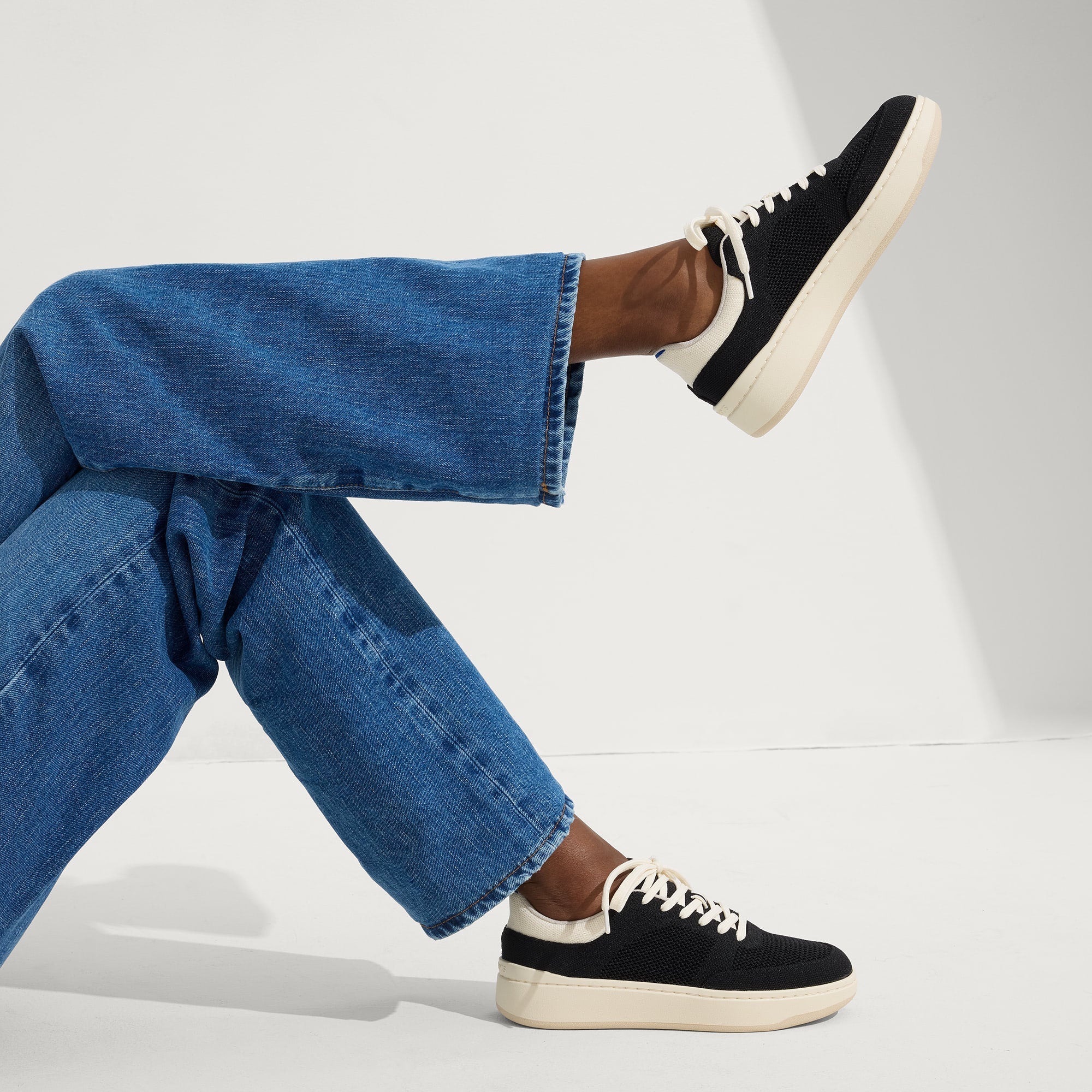 hover | Model wearing The Court Sneaker in Black.