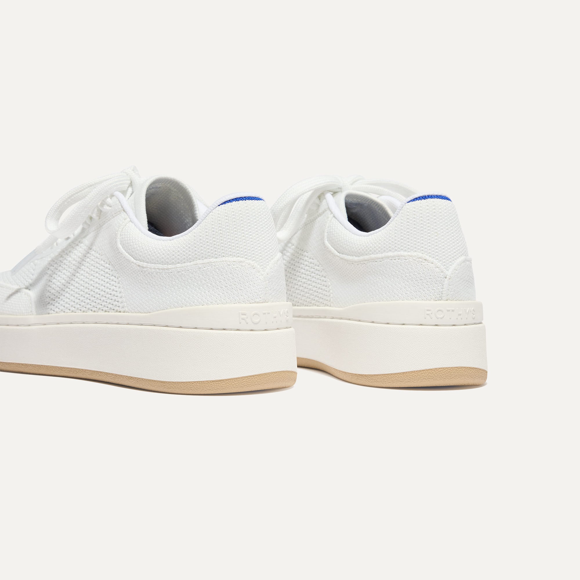 Close up of the heel of The Court Sneaker in Bright White, with Rothy's signature blue halo. 