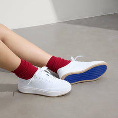 hover | Model wearing The Court Sneaker in Bright White.