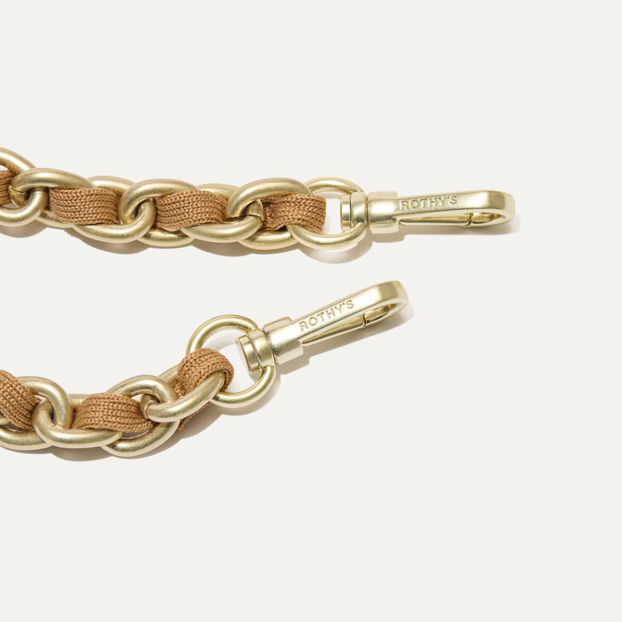 A close-up of The Crossbody Strap in Wren Chain, focusing on the end snap hooks.