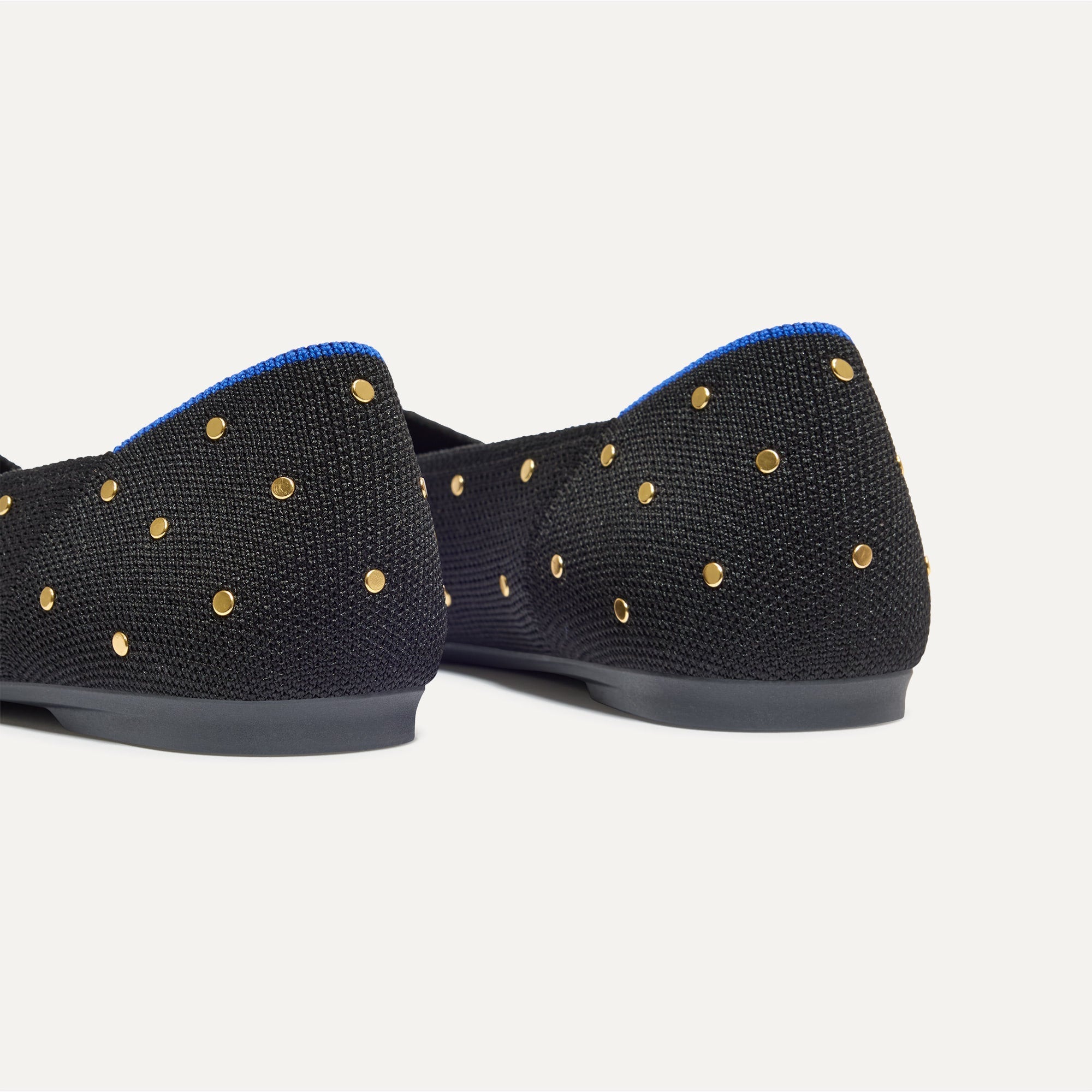 Close up of the heel of The Point II in Studded Black, with Rothy's signature blue halo. 