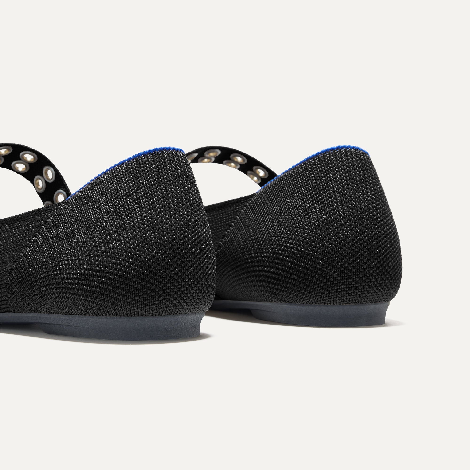 Close up of The heel of The Ballet Mary Jane in Black with Rothy's signature blue halo.