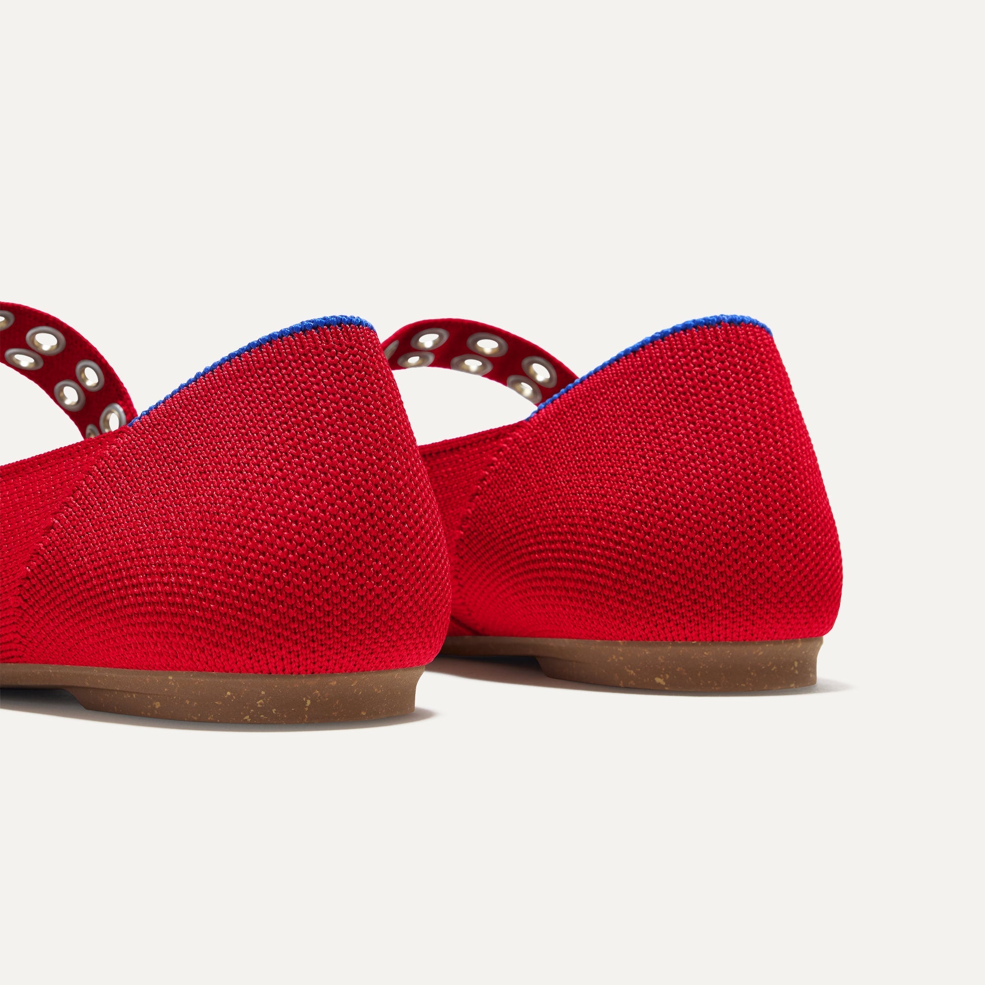 Close up of The heel of The Ballet Mary Jane in Cherry with Rothy's signature blue halo.