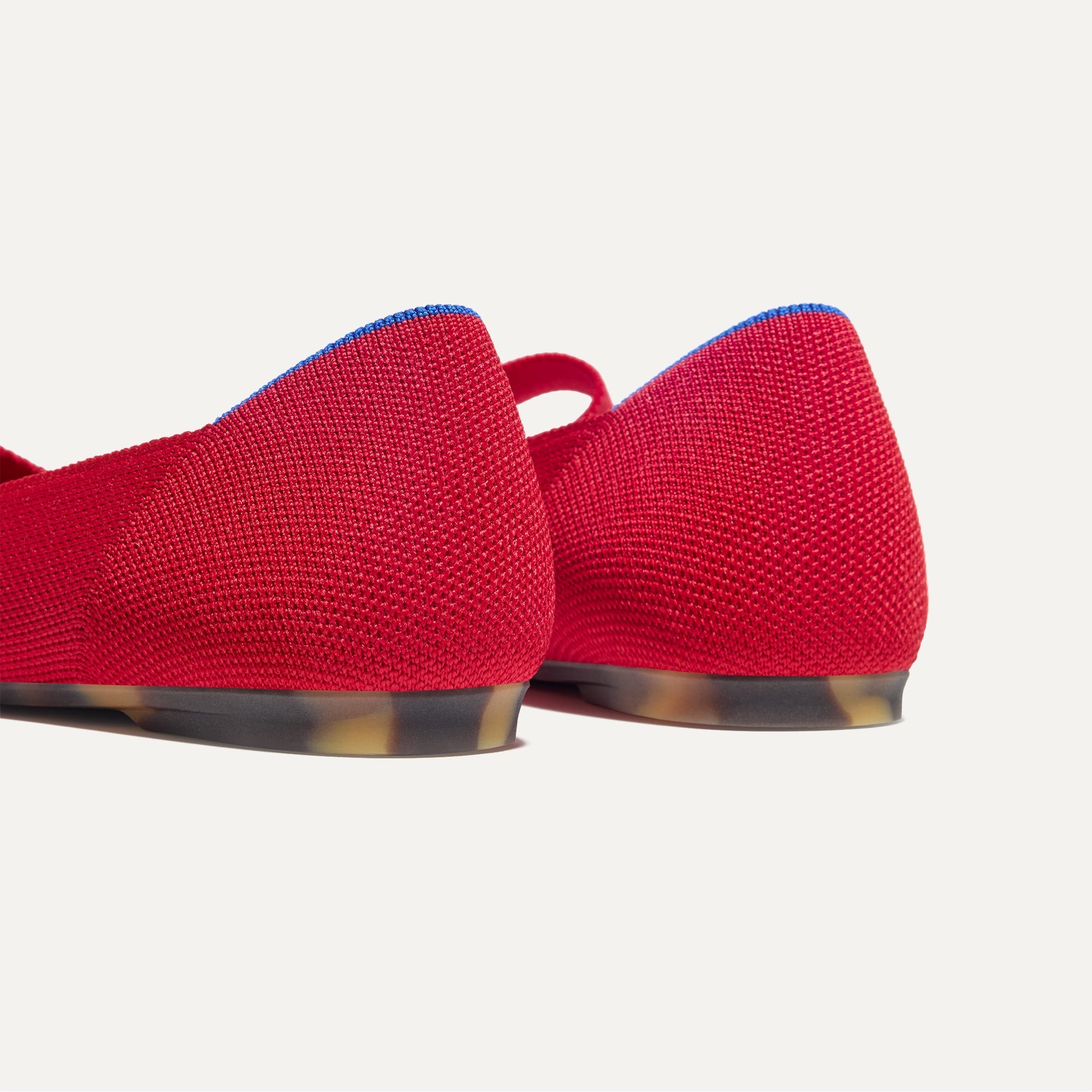 Close up of the heel of The Bow Point II in Cupid, with Rothy's signature blue halo.