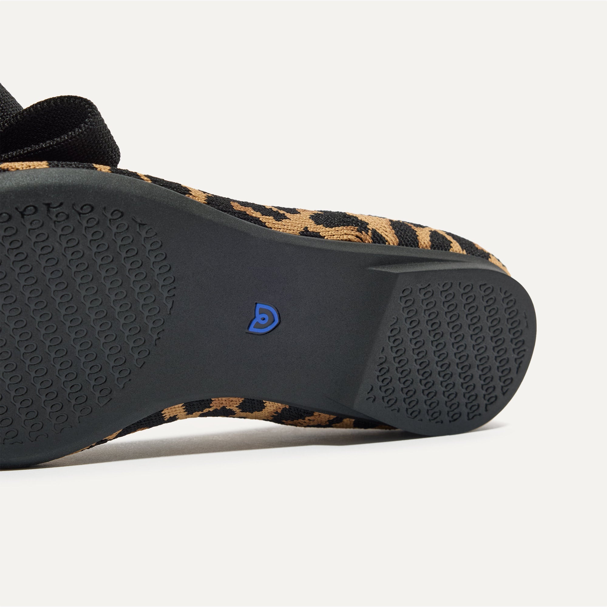 The sole of The Bow Point II in Sable Spot shown in diagonal view.