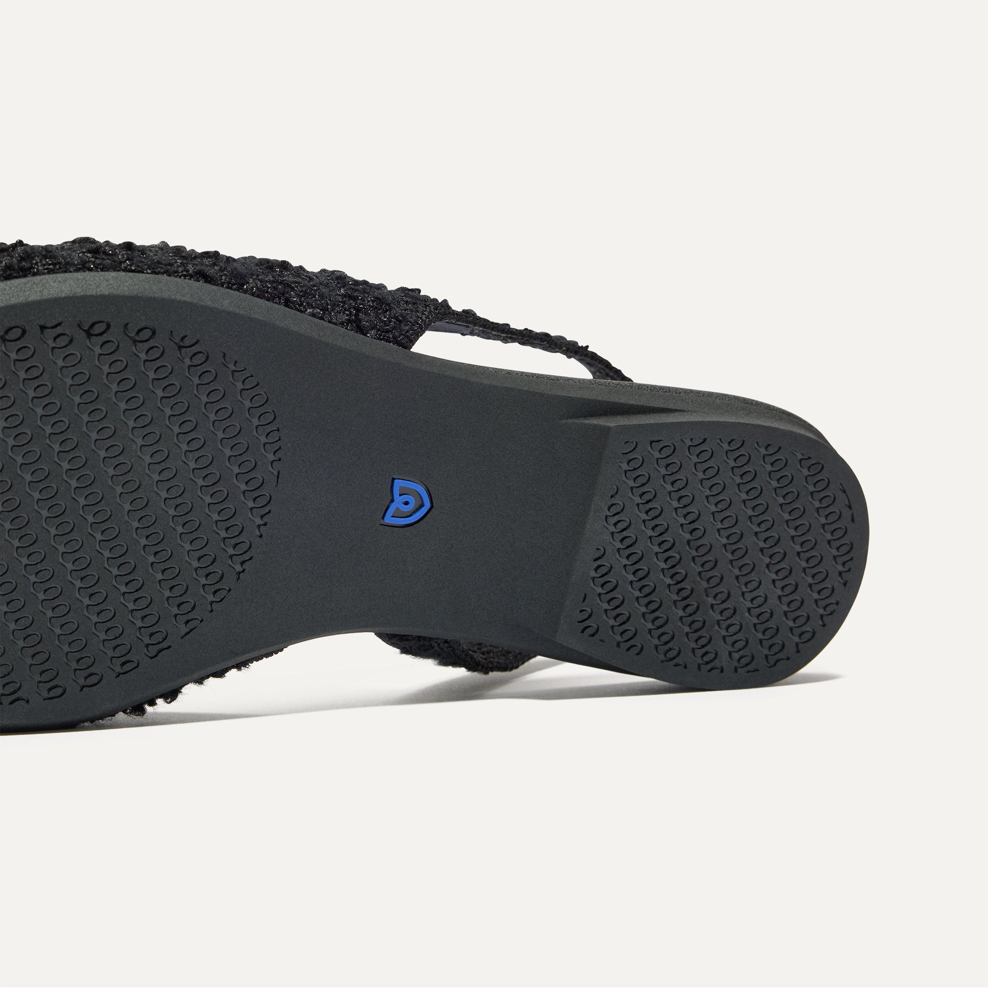 Close up of the outsole of The Almond Slingback in Black Bouclé.