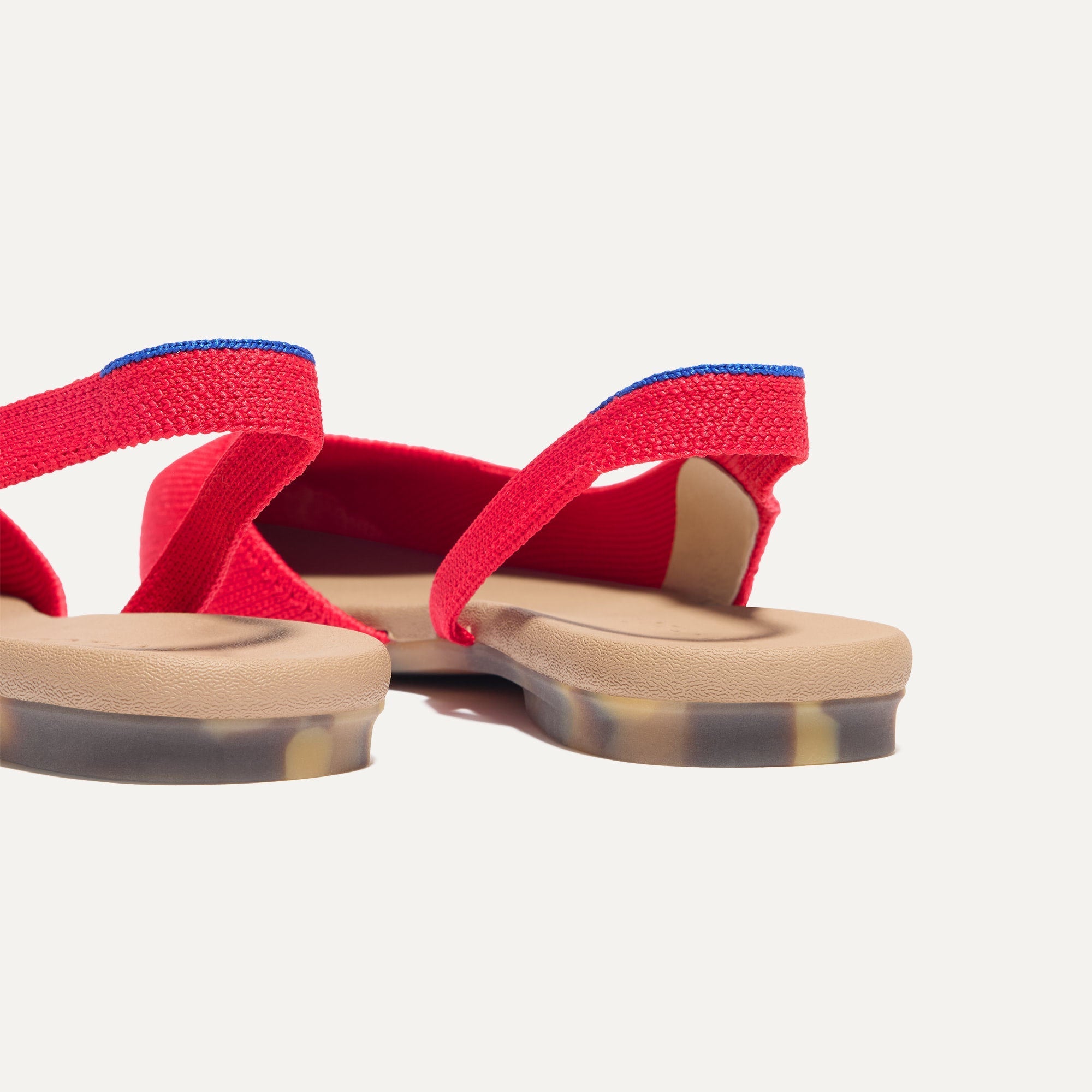 Close up of the heel The Almond Slingback in Lollipop Red, with Rothy's signature blue halo.