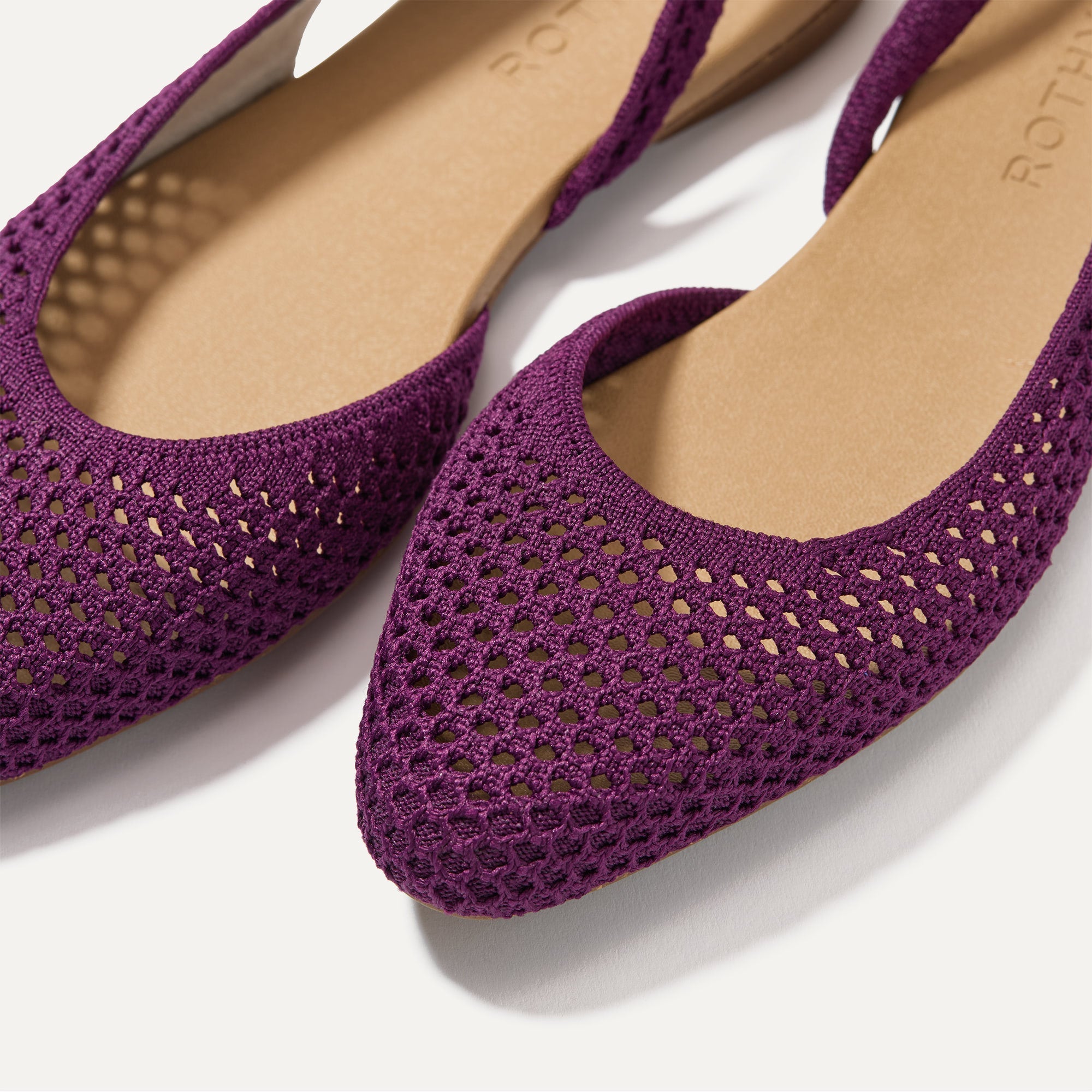 Close up of the strap on The Almond Slingback in Plum Mesh, with Rothy's signature blue halo.
