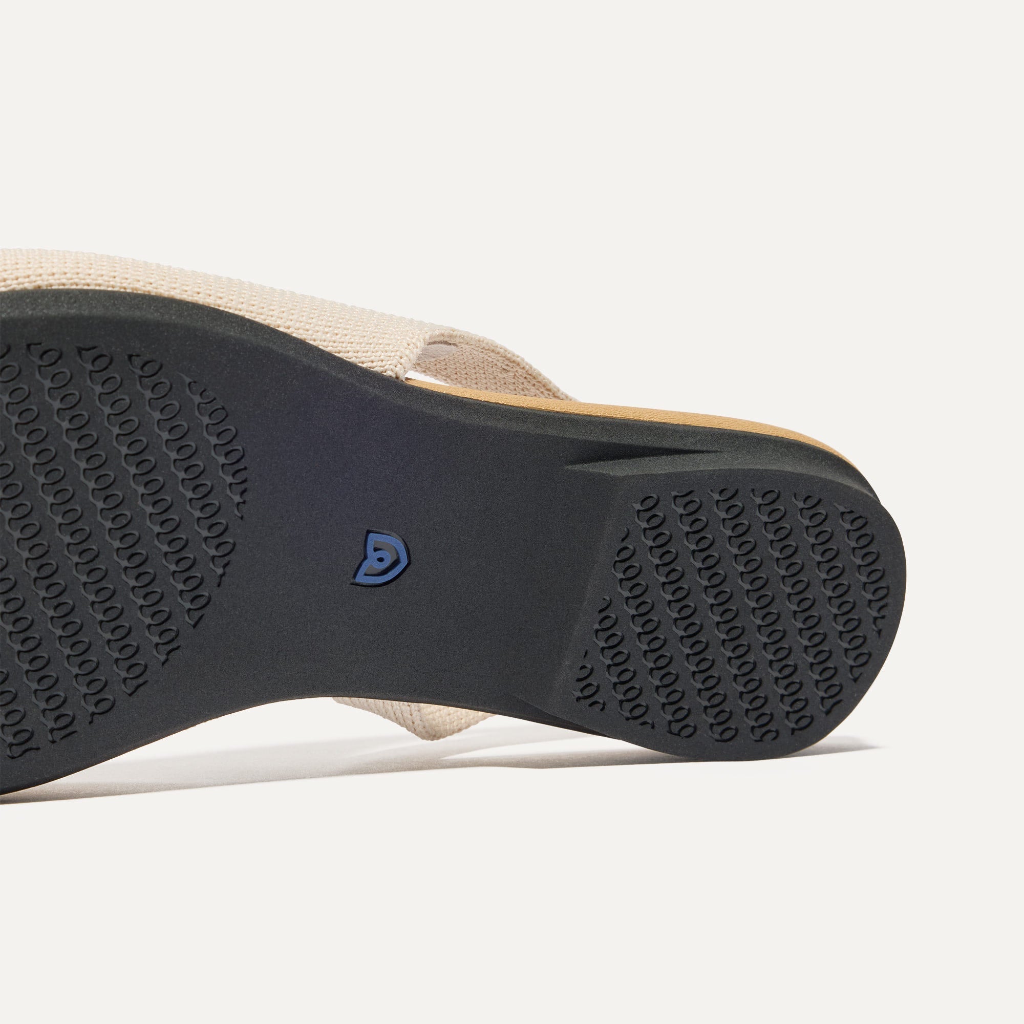 Close up of the outsole of The Almond Slingback in Conch Captoe.