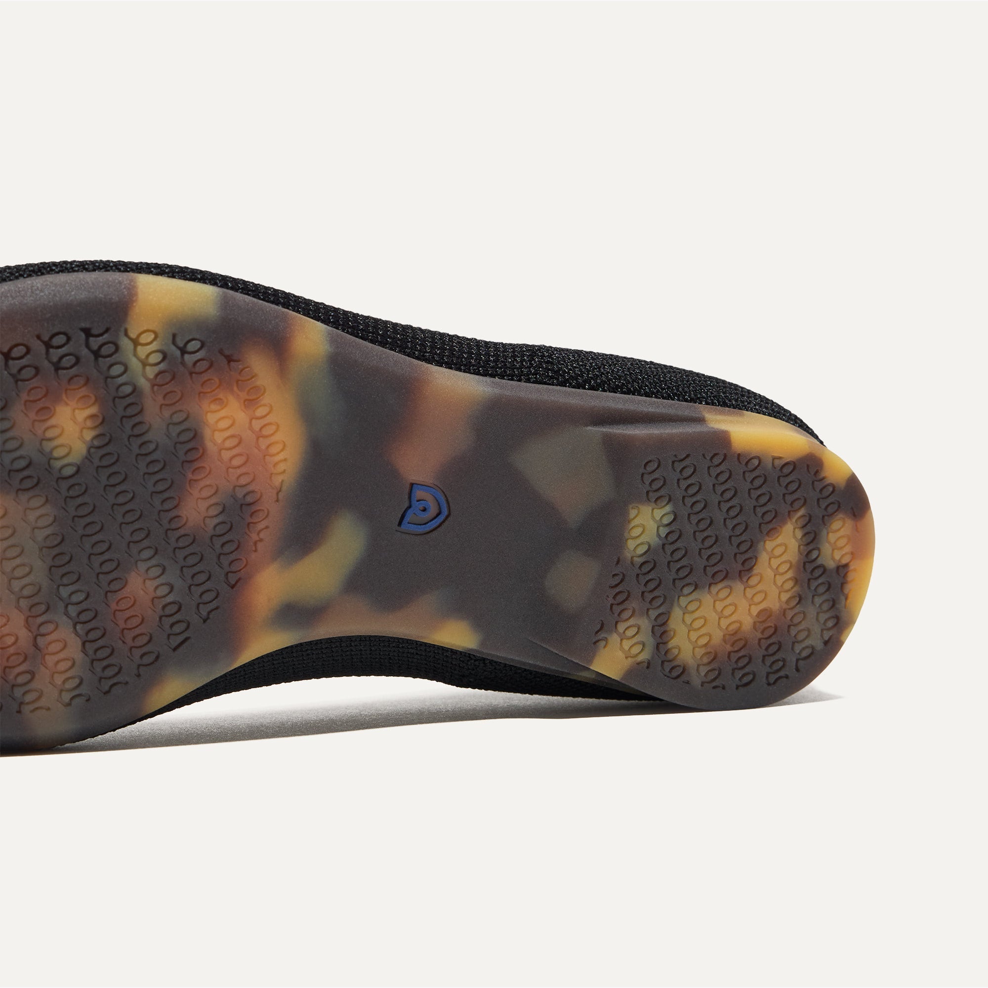 Close up of the outsole of The Emblem Point II in Black, shown in a diagonal view. 