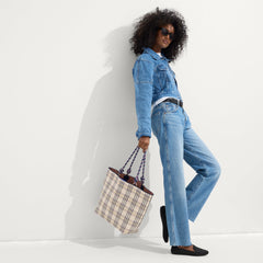 An alternate view of model holding The Lightweight Tote in Spring Plaid.