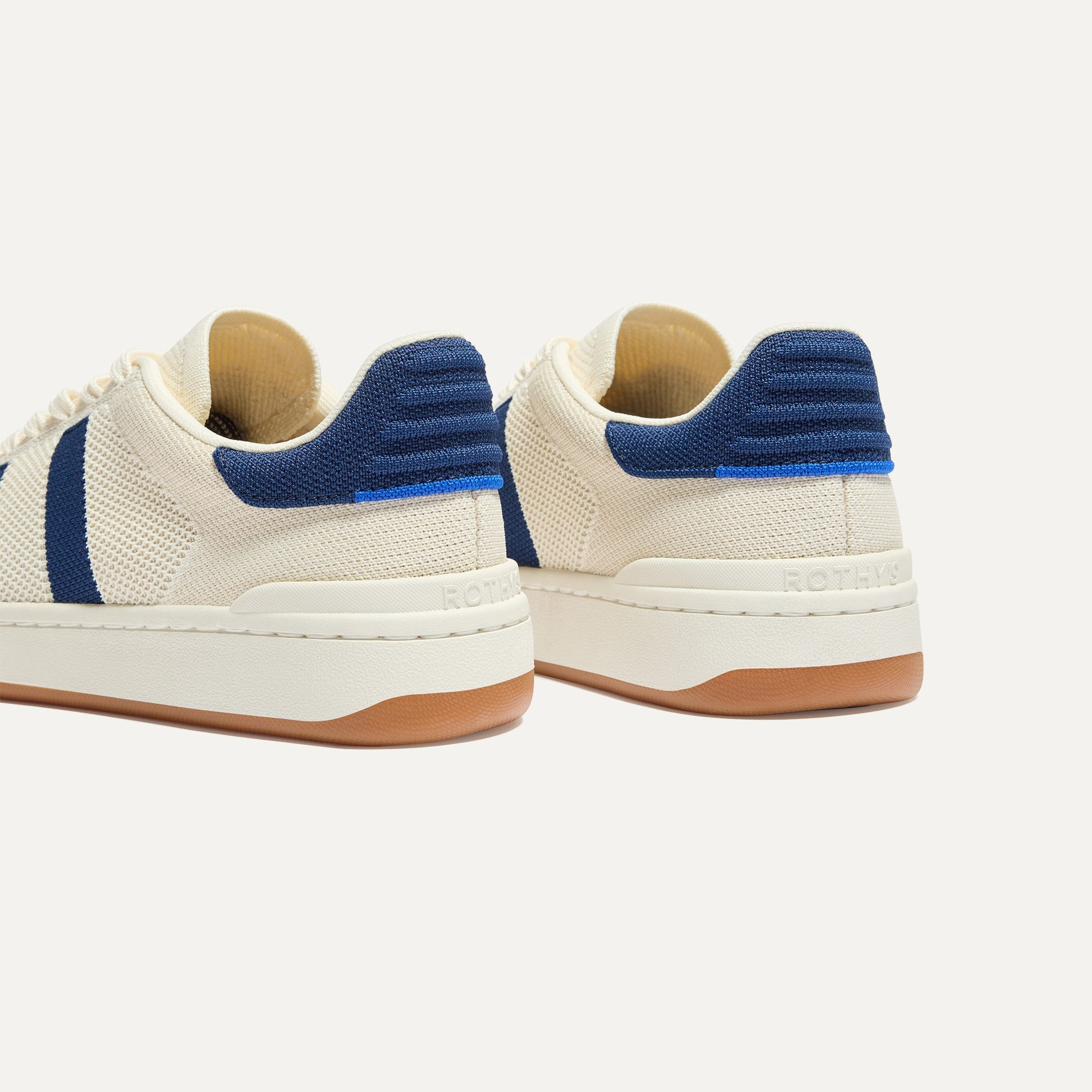 Close up of the heel of The Men's Court Sneaker in Freestyle, with Rothy's signature blue halo. 