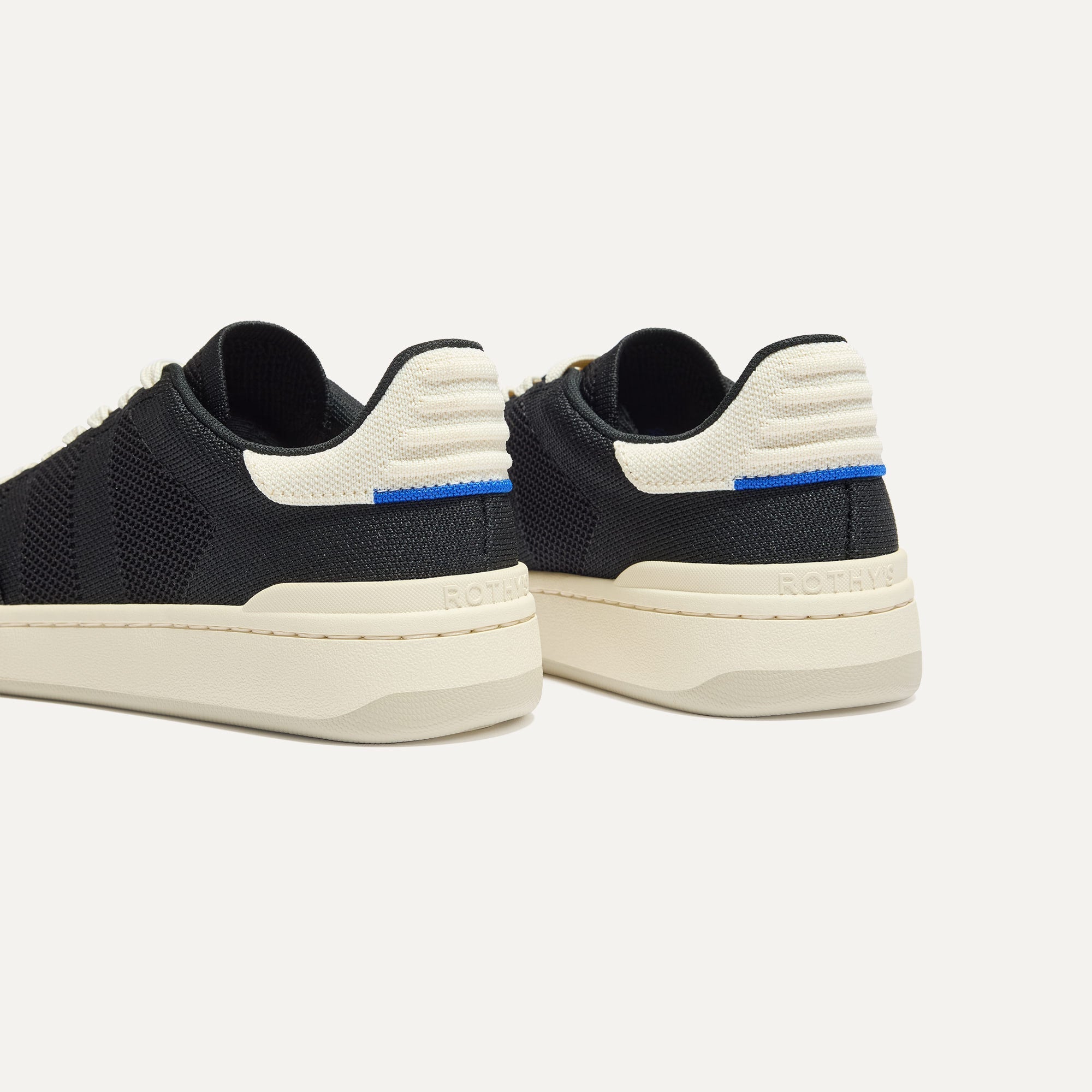 Close up of the heel of The Men's Court Sneaker in Referee, with Rothy's signature blue halo. 