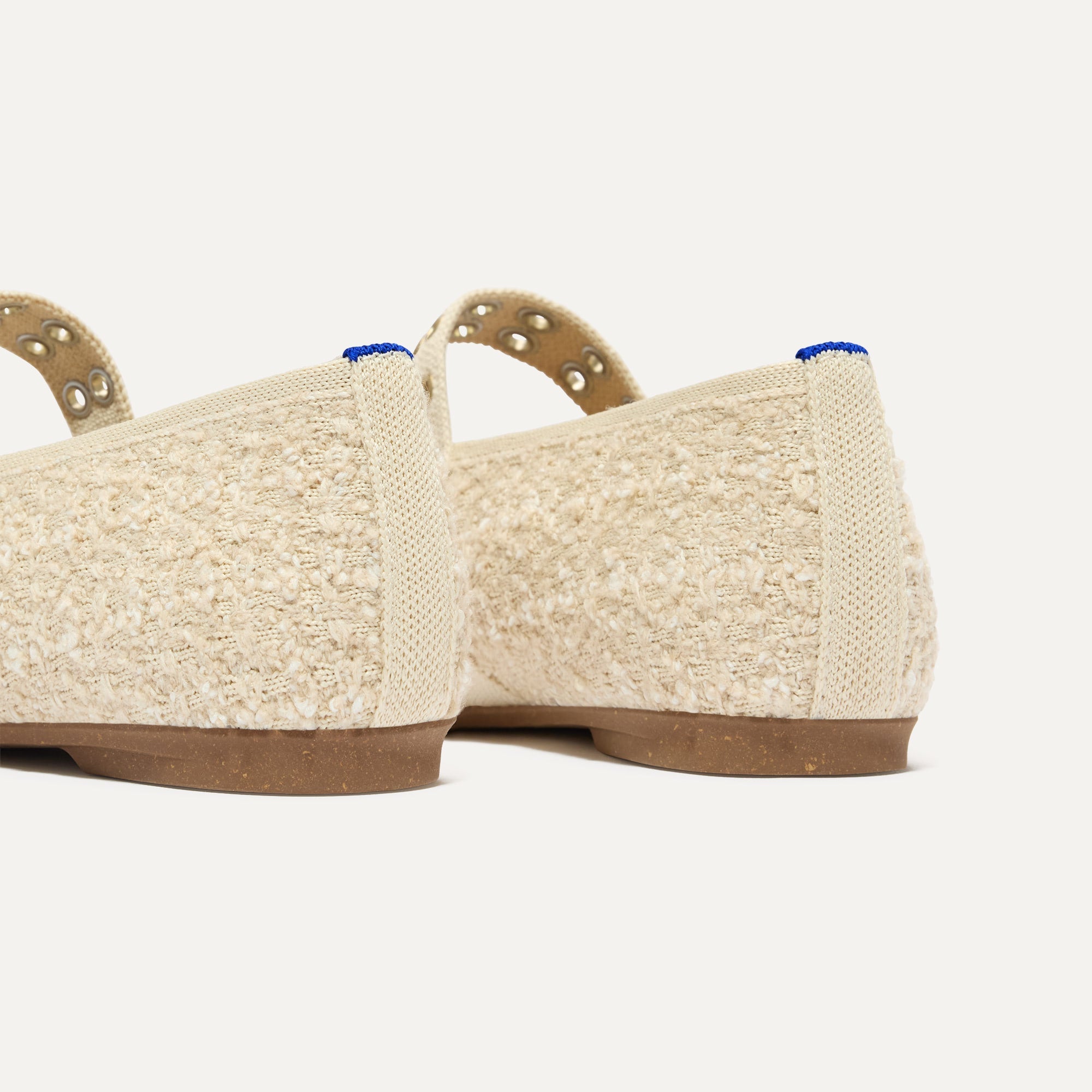 Close up of the heel of The Max Buckle Mary Jane in Pearl Bouclé, with Rothy's signature blue halo.