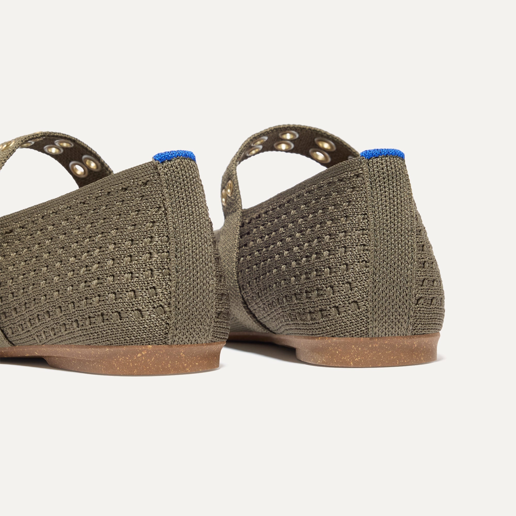 Close up of the heel of The Max Buckle Mary Jane in Safari Mesh, with Rothy's signature blue halo.