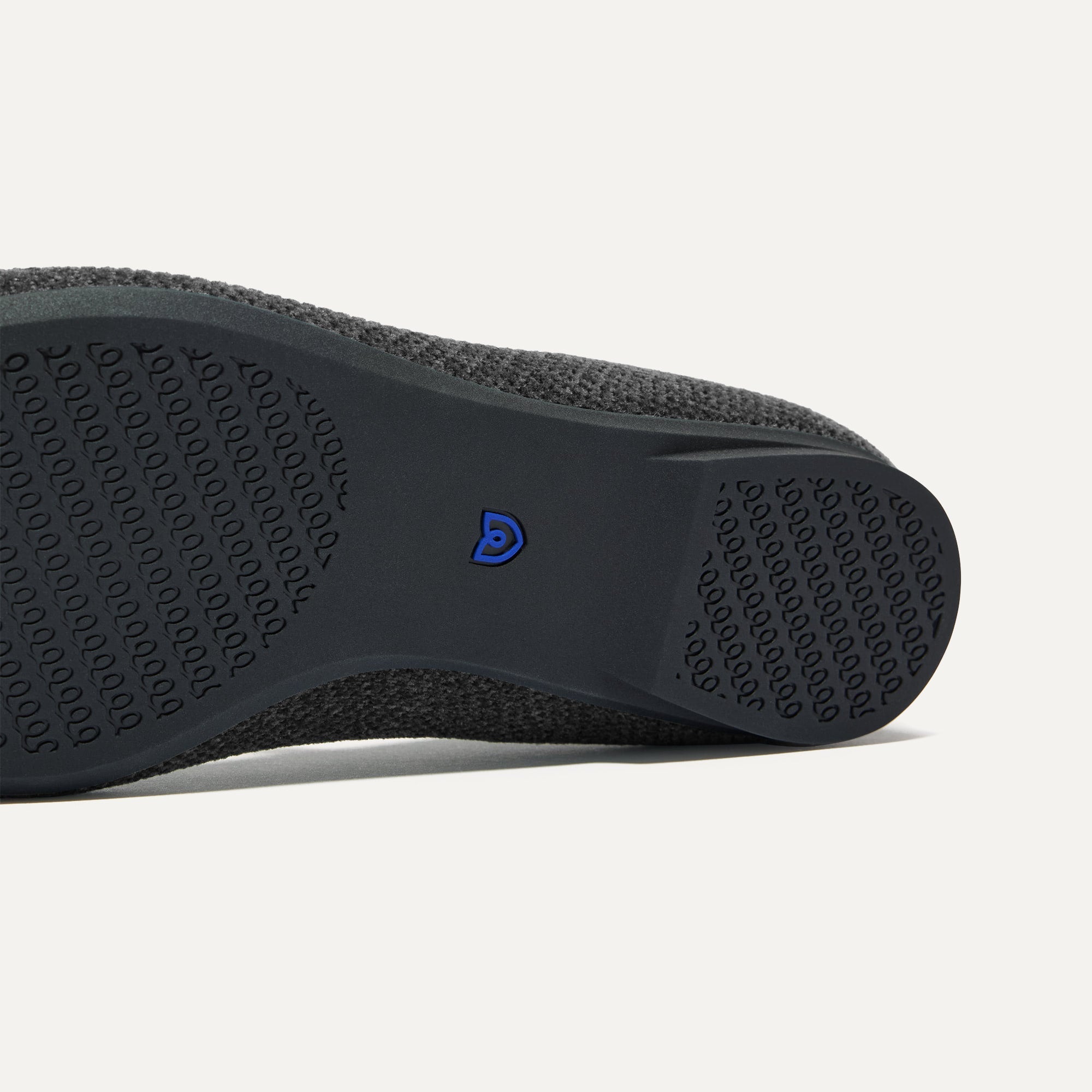 The sole of The Max Square Mary Jane in ReVelvet™ Black shown in diagonal view.