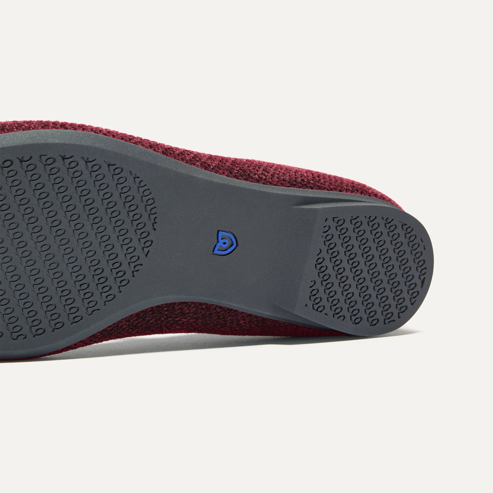 The sole of The Max Square Mary Jane in ReVelvet™ Syrah shown in diagonal view.