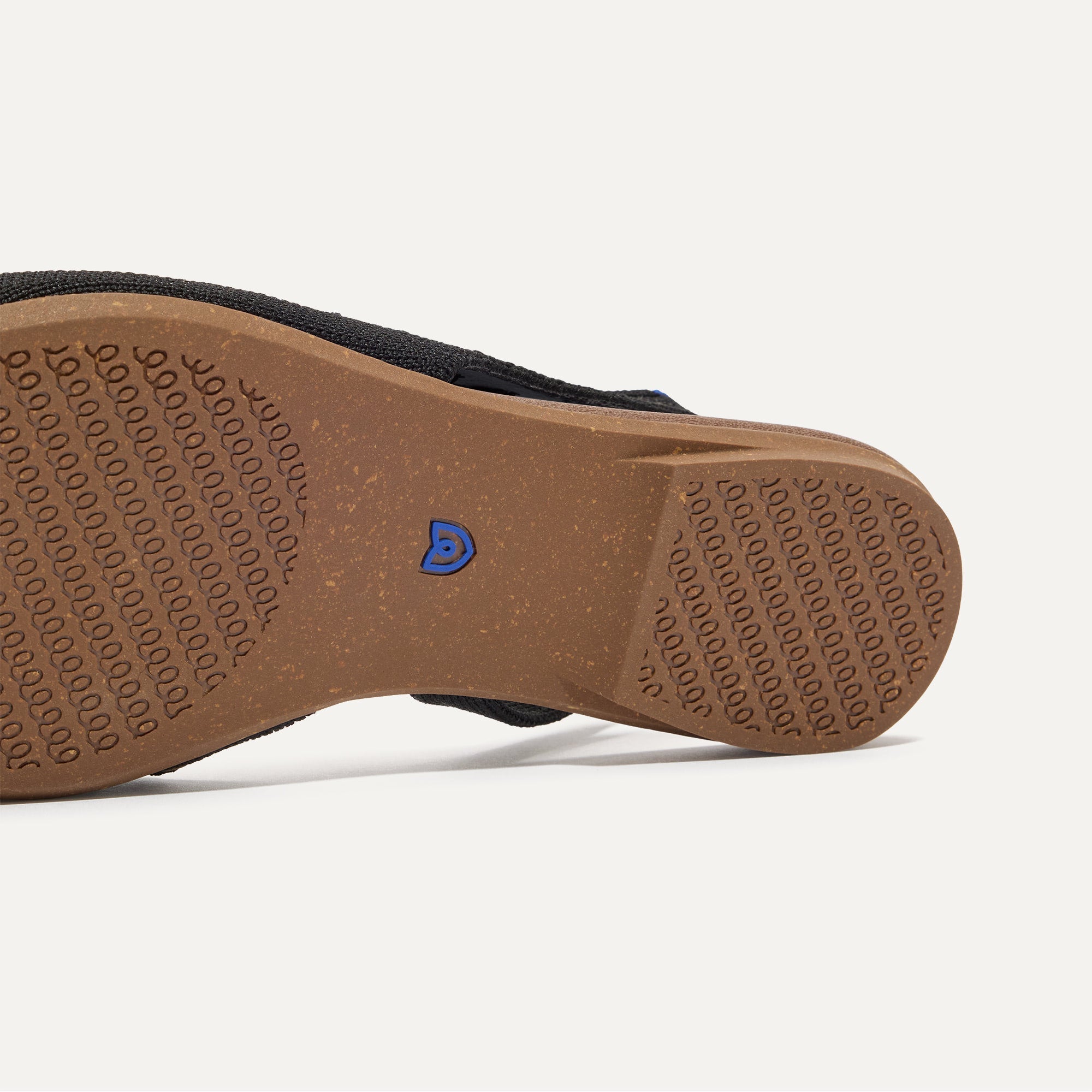 Close up of the outsole of The Almond Slingback in Eyelet Black.