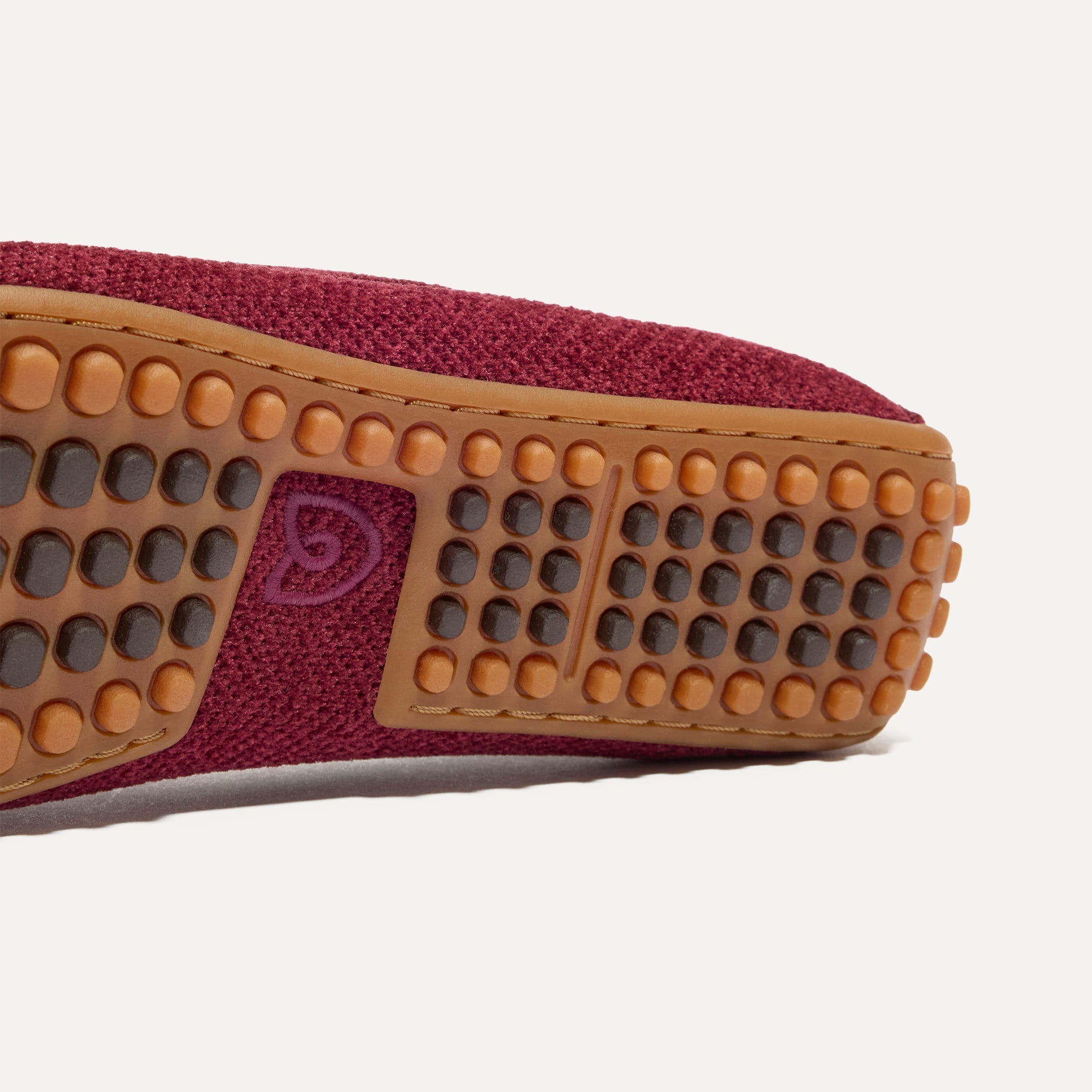 Close up of the raised nub outsoles of The Double Bit Driver in ReVelvet™ Cabernet.
