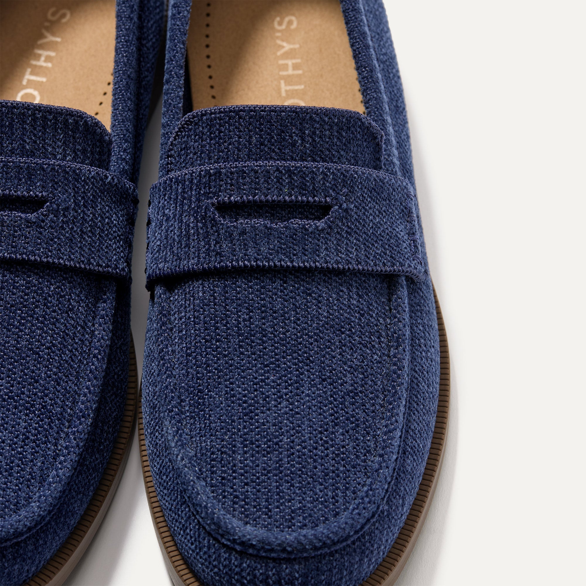 Close up of the toe box and penny keeper of The Penny Loafer in ReVelvet™ Navy.