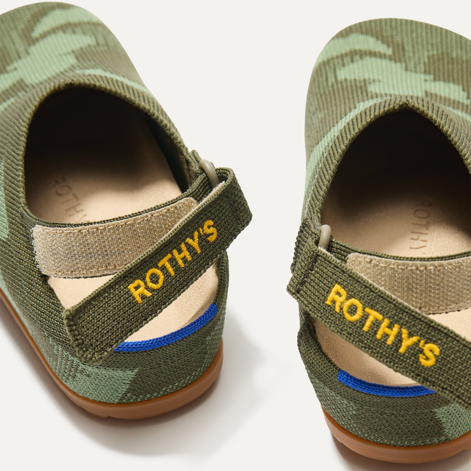 Close up of the back heel strap of The Kids Clog in Green Camo.