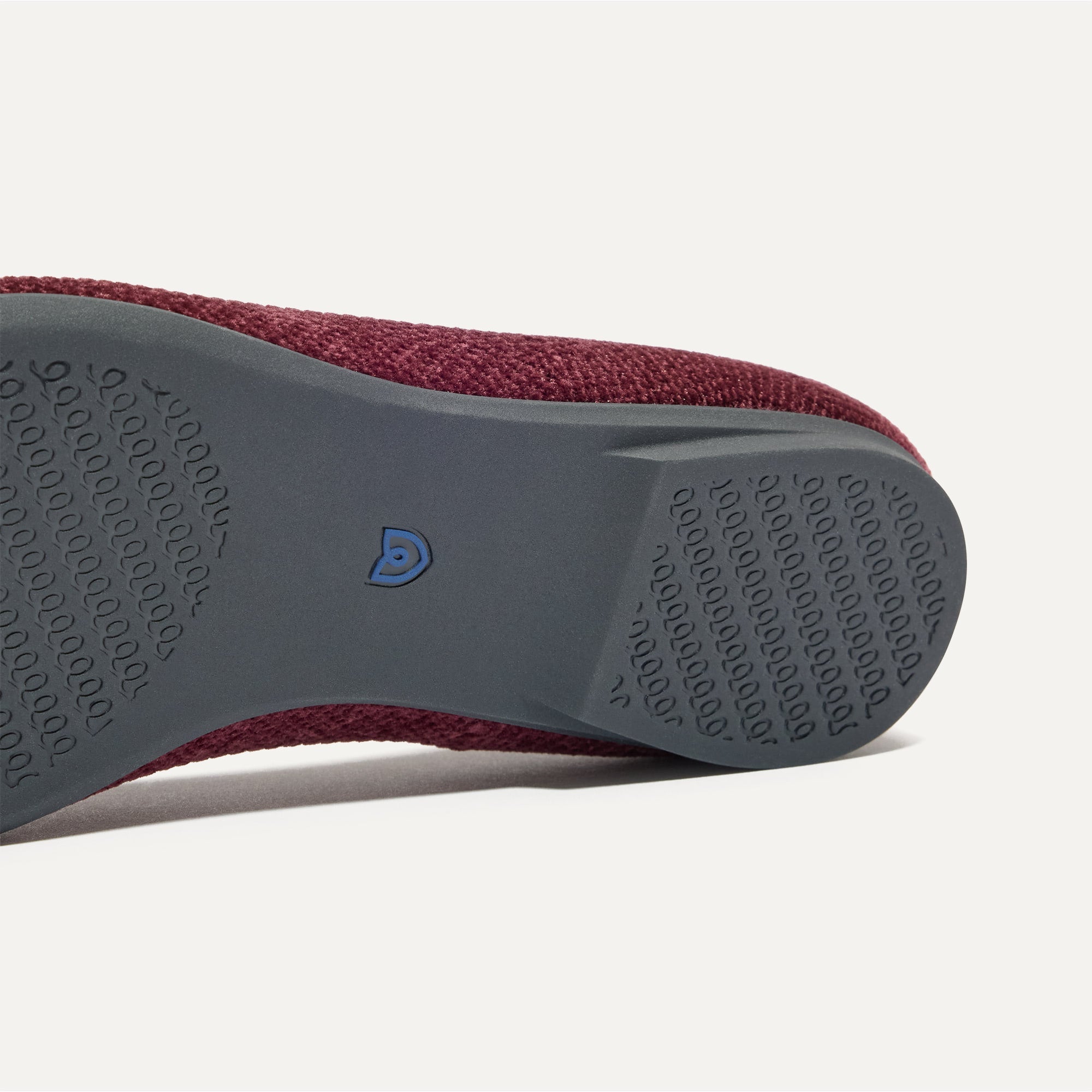 Close up of the outsole of The Emblem Point II in ReVelvet™ Syrah, shown in a diagonal view. 