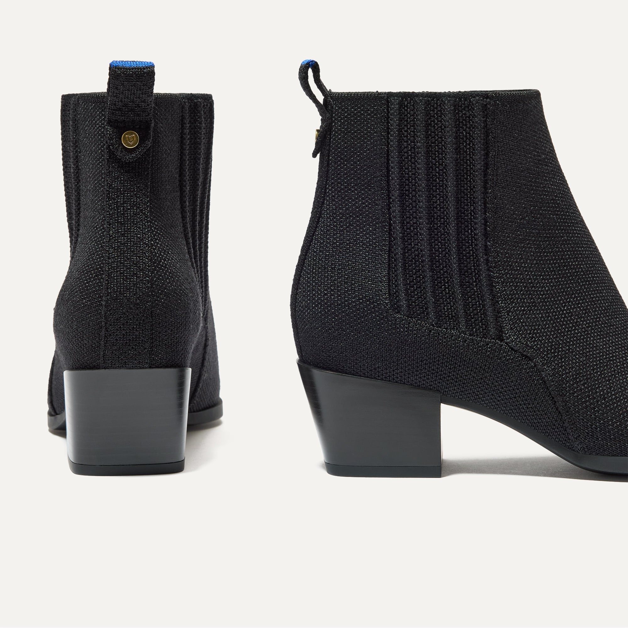 A pair of The Western Bootie in Black shown from the back.