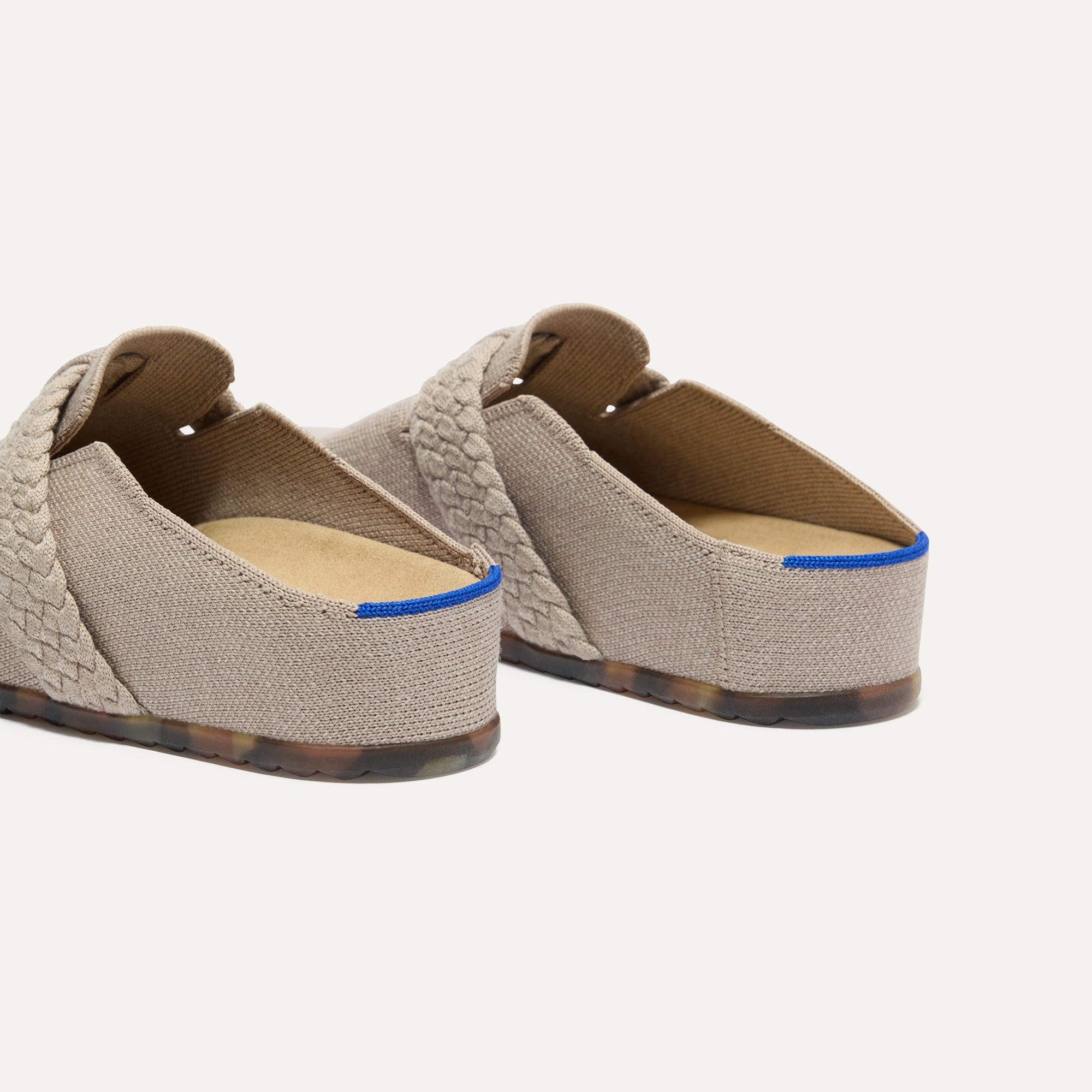 Close up of the heel of The Braid Clog in Dove, with Rothy's signature blue halo. 