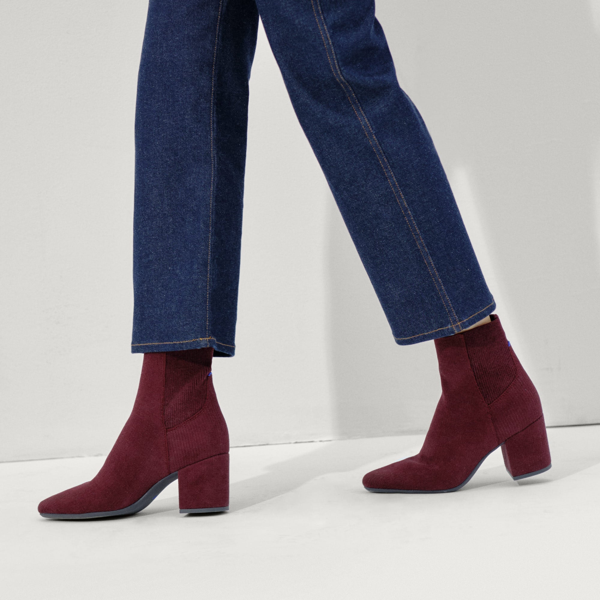 hover | Model wearing The High Classic Boot in ReVelvet™ Syrah.