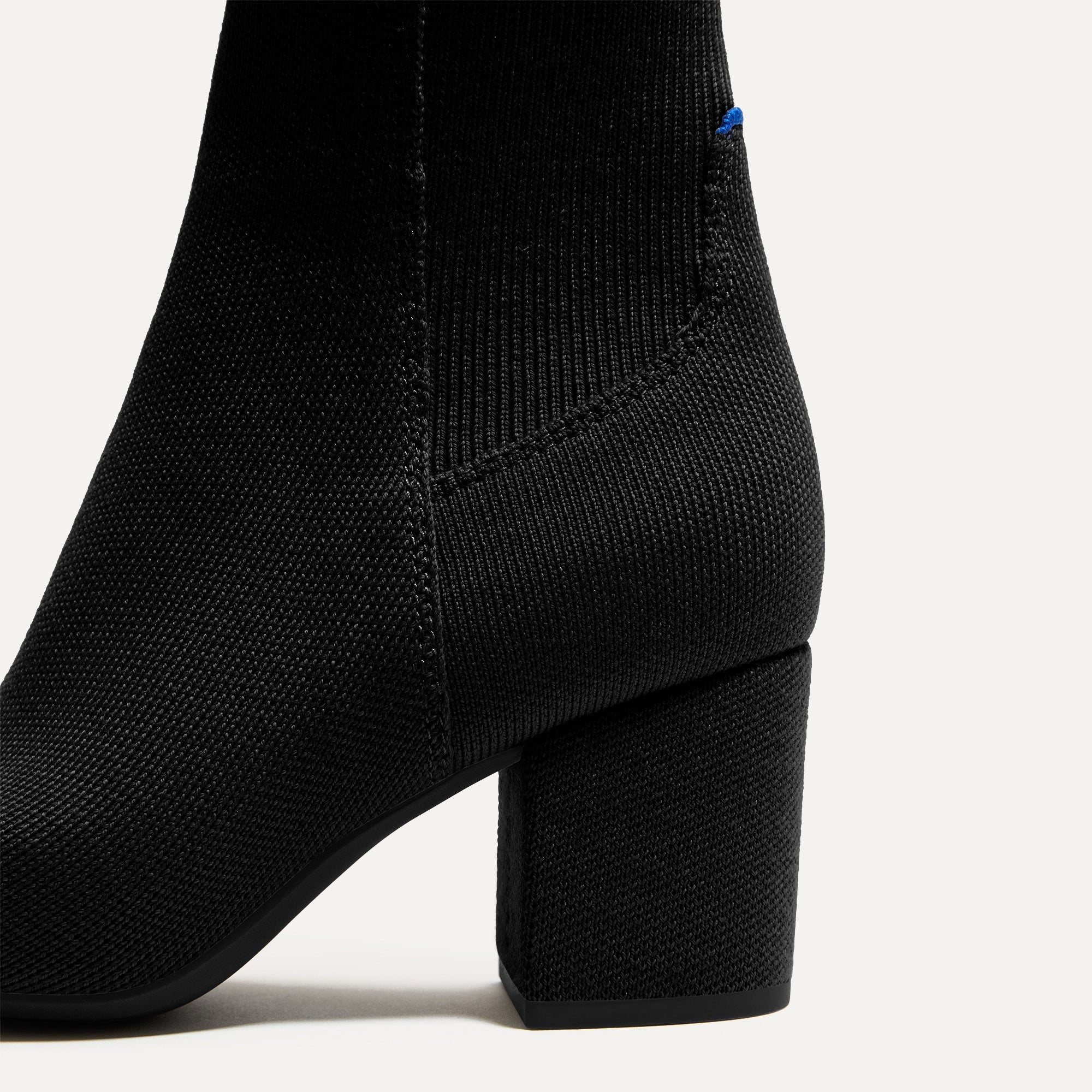 Close up of the block heel of The High Classic Boot in Black.