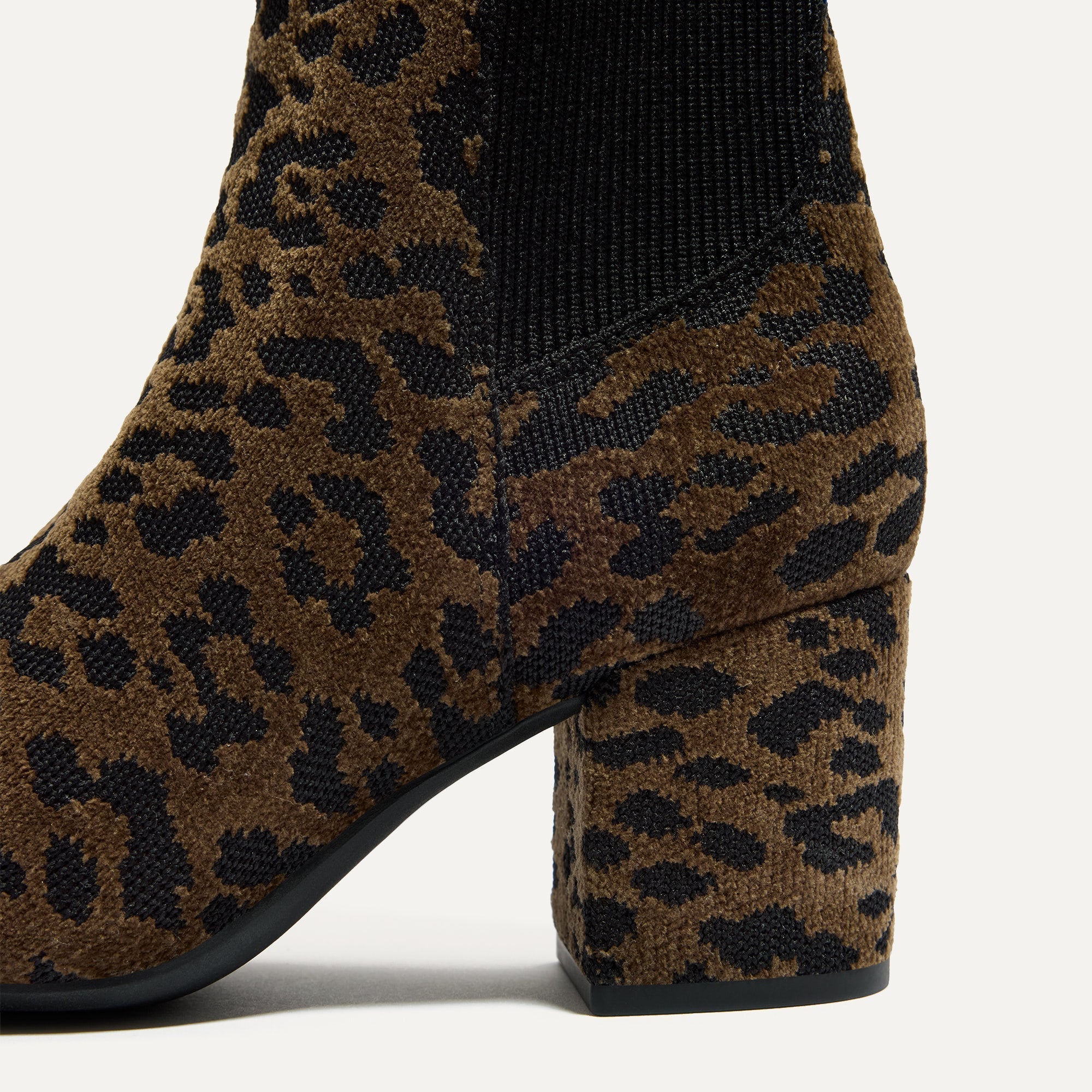 Close up of the block heel of The High Classic Boot in ReVelvet™ Cheetah.