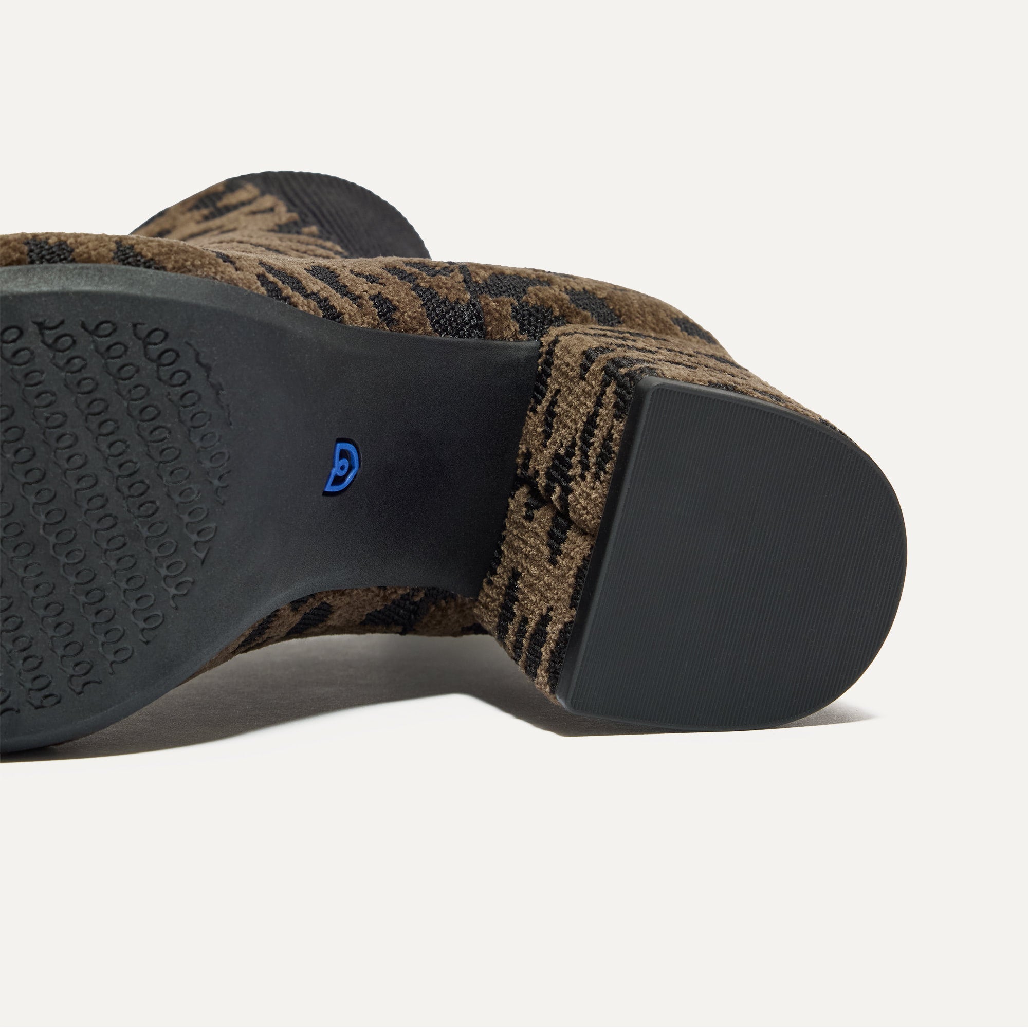 Close up of the outsoles of The High Classic Boot in ReVelvet™ Cheetah.