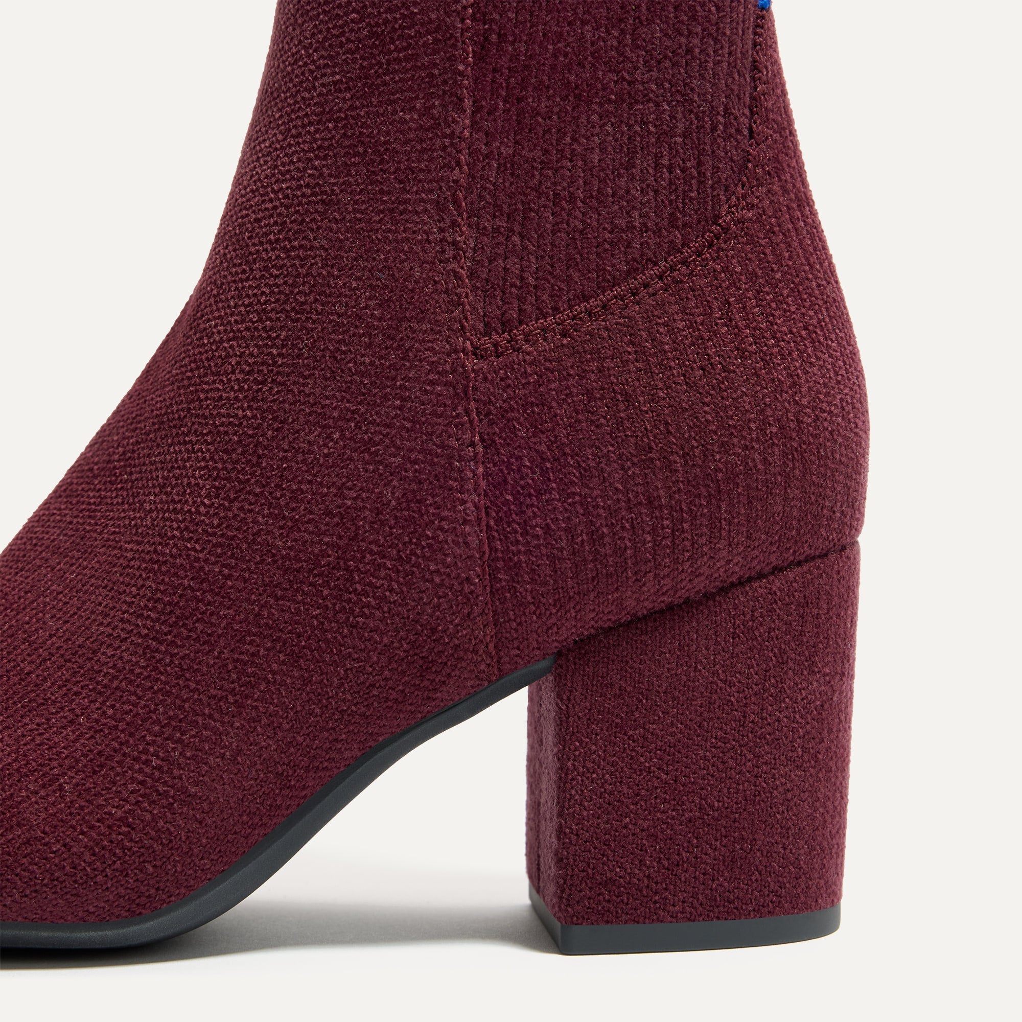 Close up of the block heel of The High Classic Boot in ReVelvet™ Syrah.