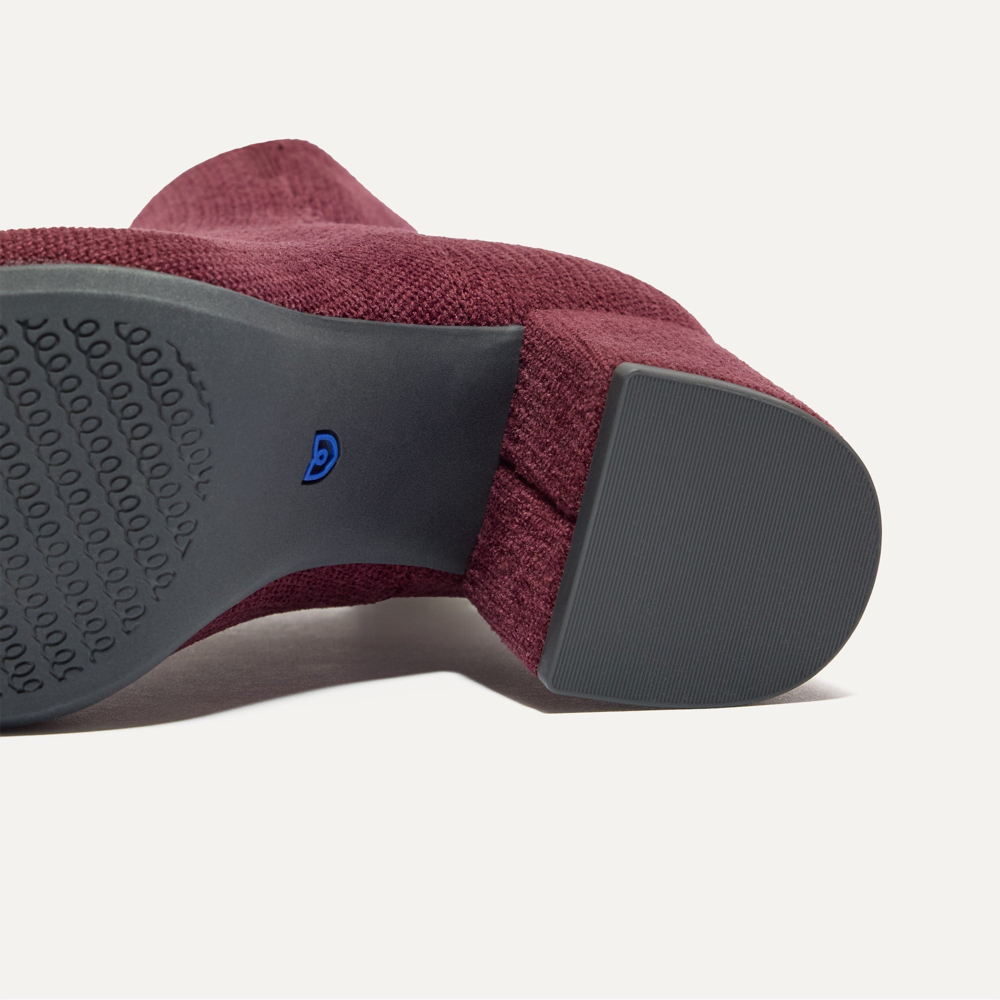 Close up of the outsoles of The High Classic Boot in ReVelvet™ Syrah.