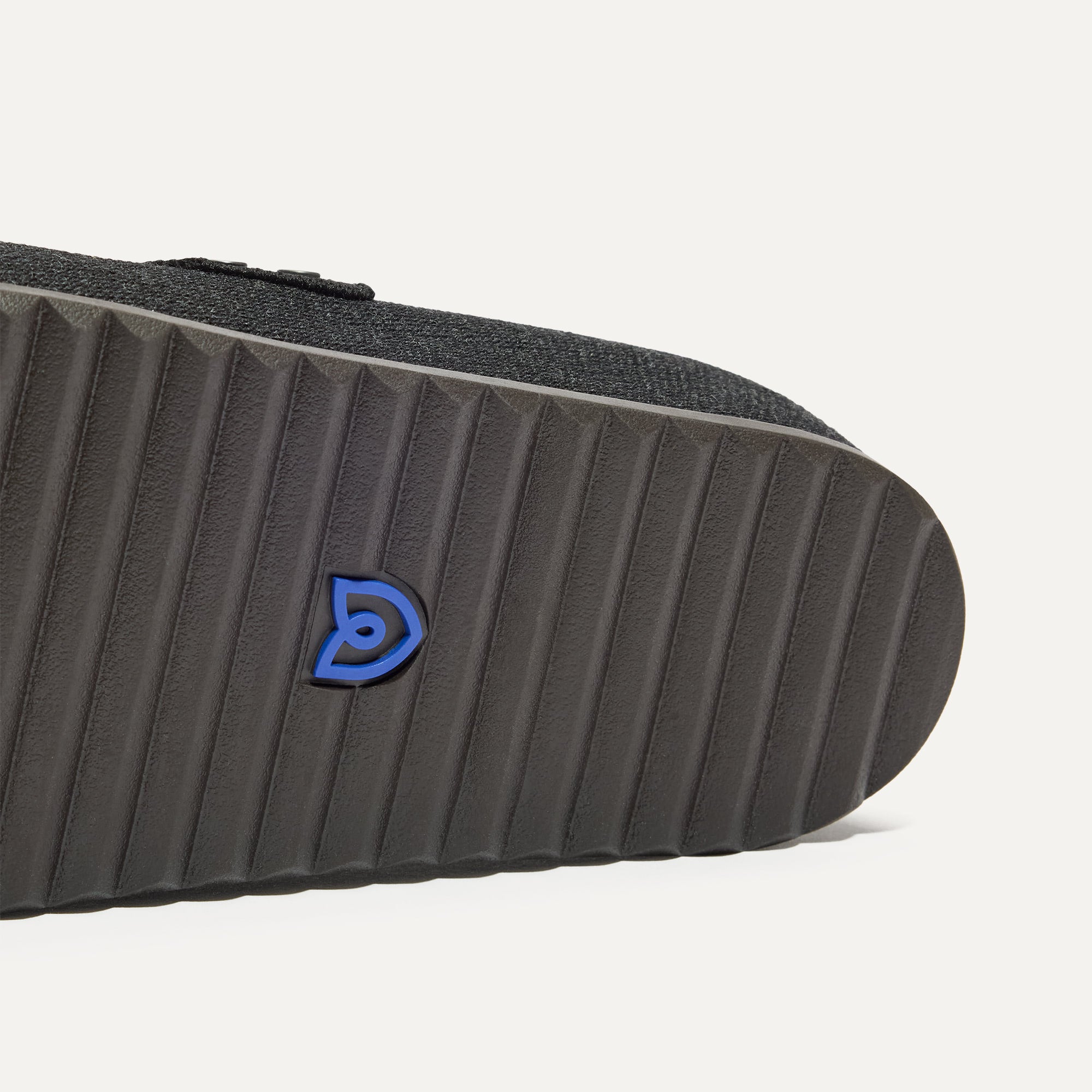 Close up of the outsoles of The Men's Cozy Clog in Black.