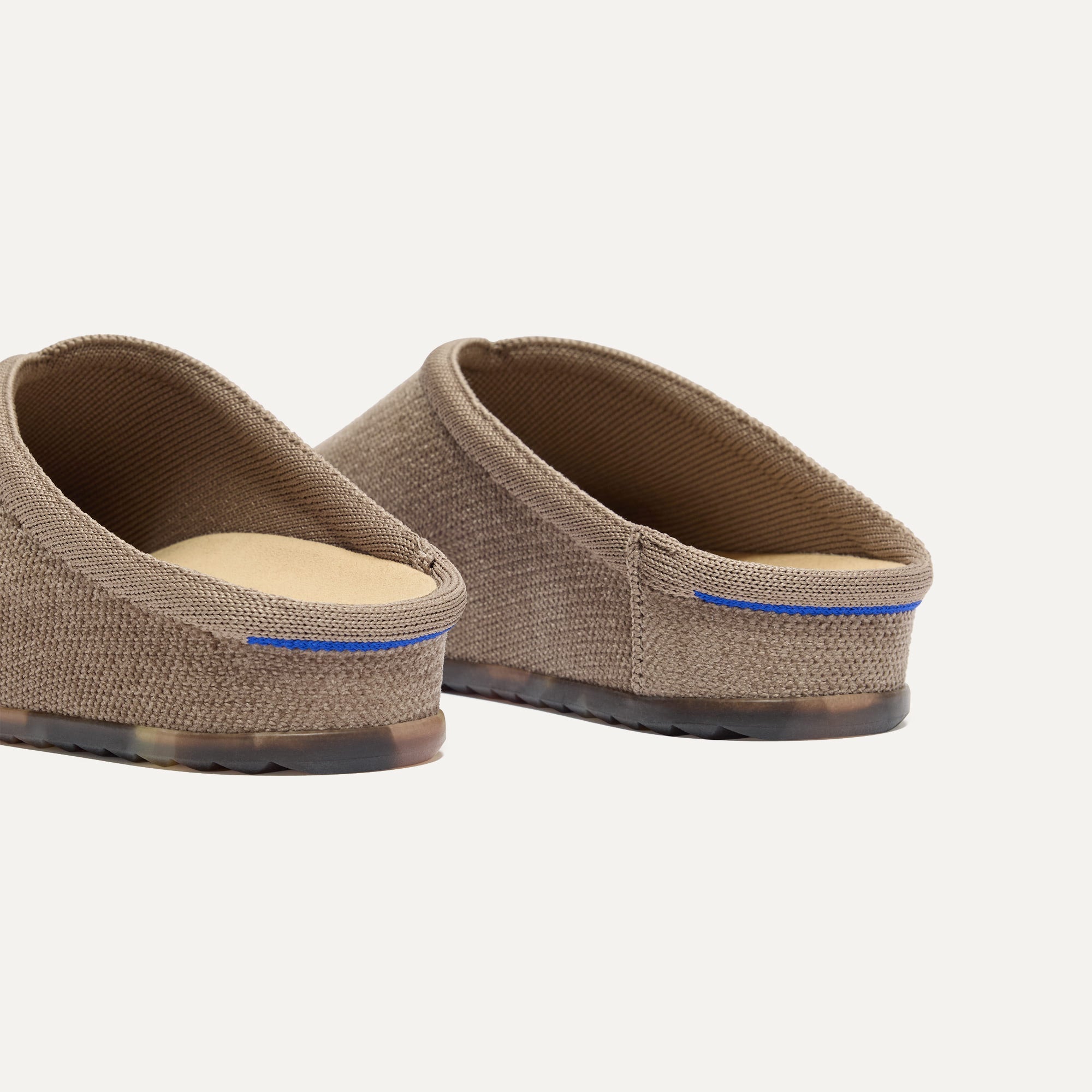 Close up of the heel of The Casual Clog in ReVelvet™ Portobello, with Rothy's signature blue halo. 