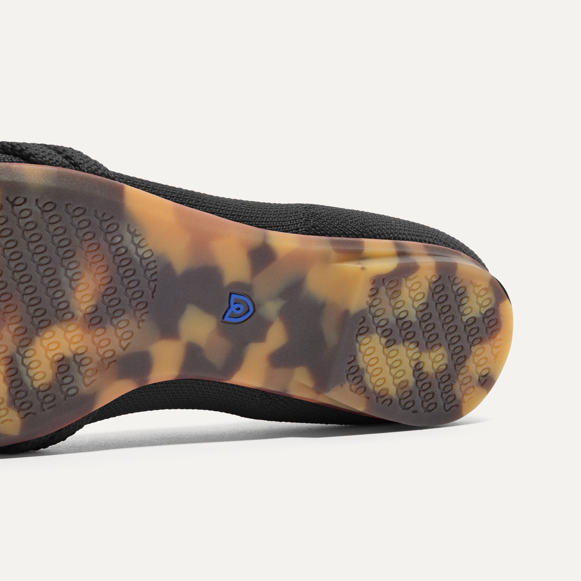 The sole of The Knot Ballet Flat in Black shown in diagonal view.