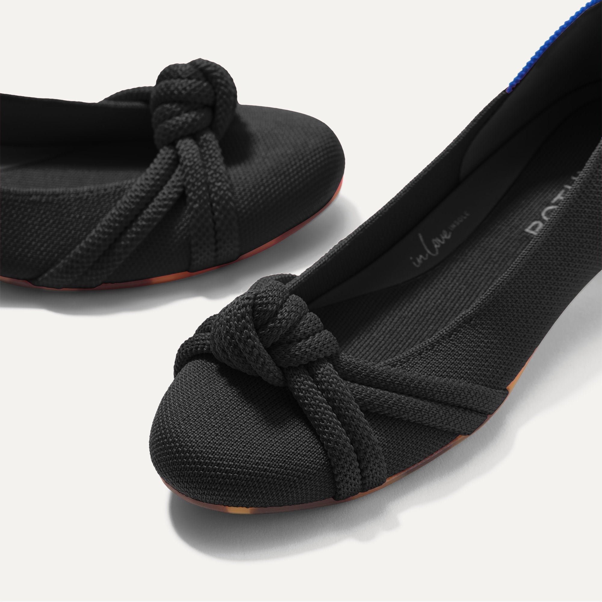 Close up of the rounded toe and knotted detail of The Knot Ballet Flat in Black.