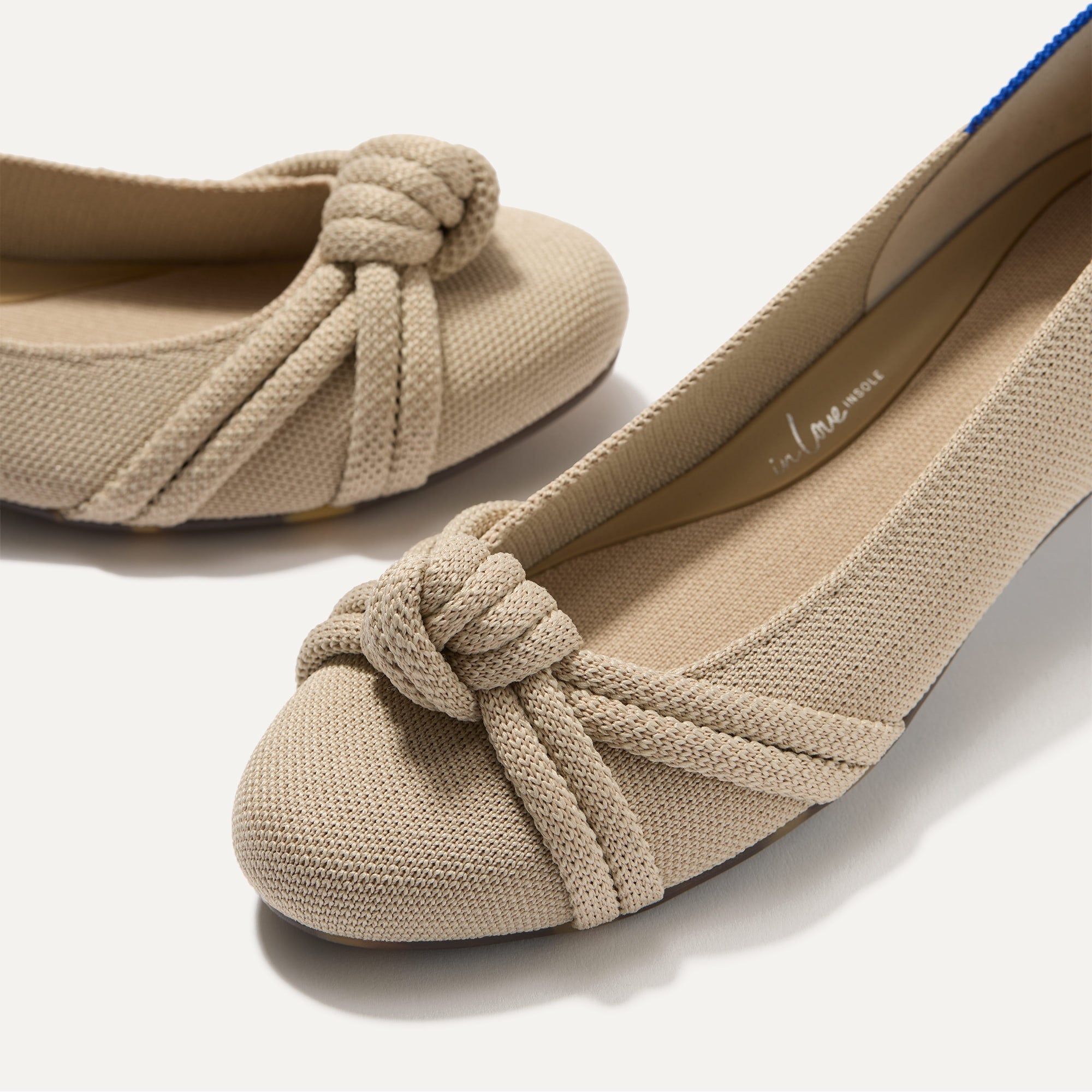 Close up of the rounded toe and knotted detail of The Knot Ballet Flat in Ecru.