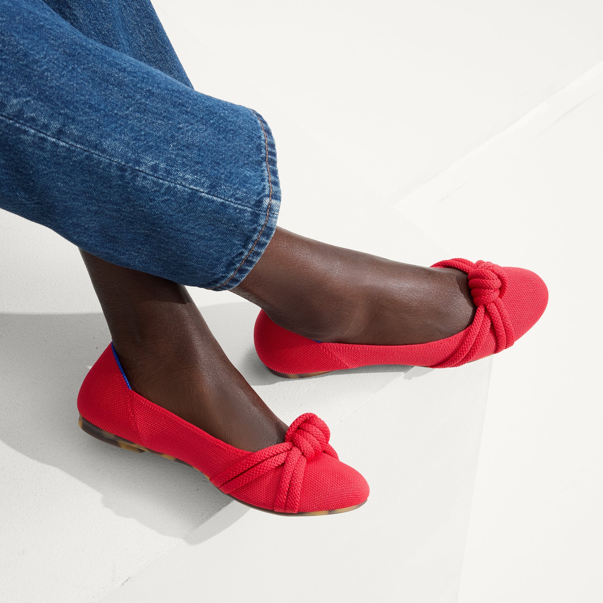 hover | Model wearing The Knot Ballet Flat in Lollipop Red.
