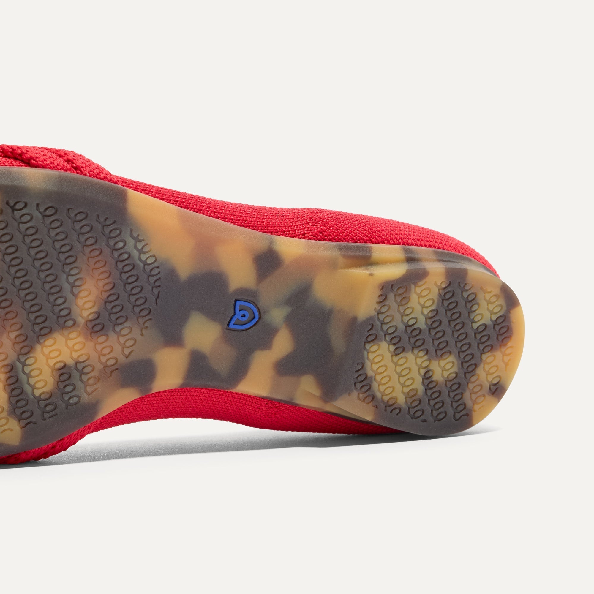 The sole of The Knot Ballet Flat in Lollipop Red shown in diagonal view.