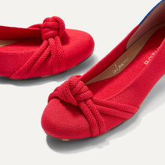Close up of the rounded toe and knotted detail of The Knot Ballet Flat in Lollipop Red.