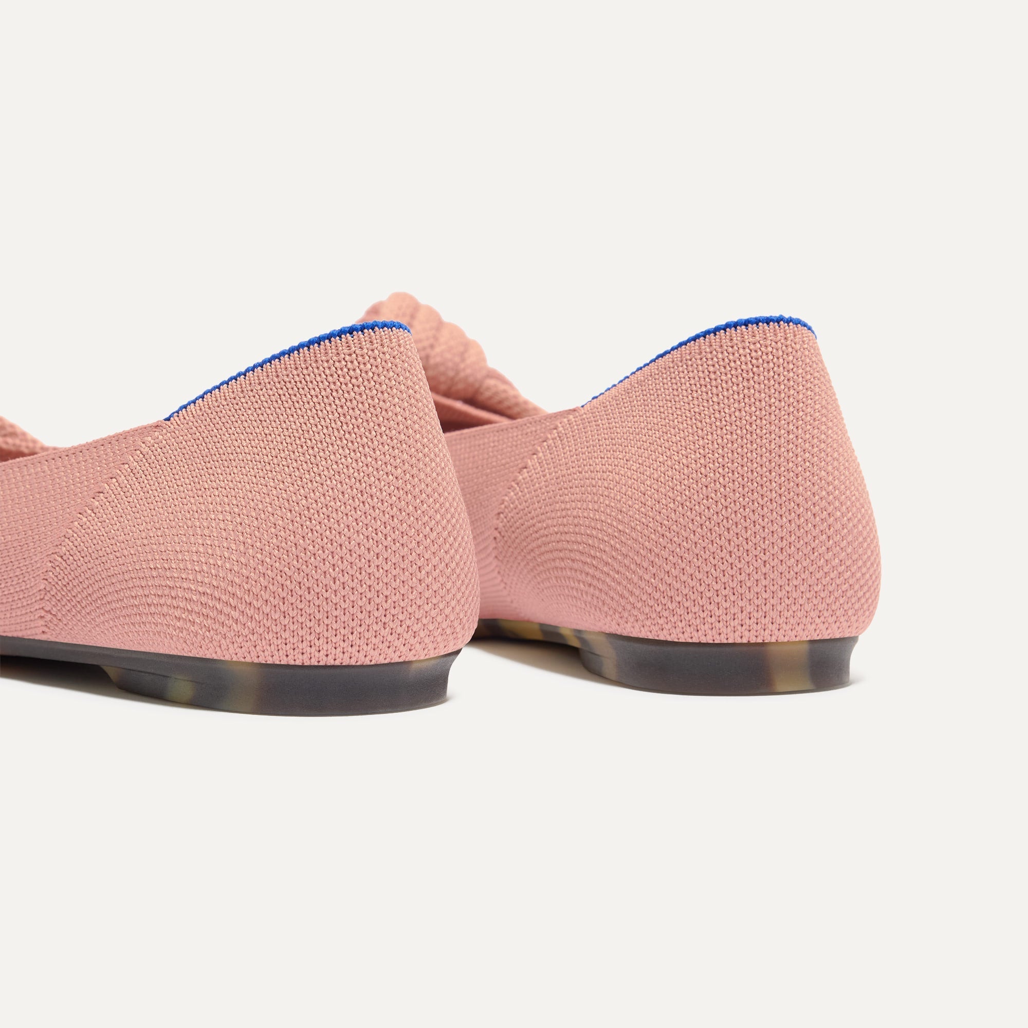 Close up of the heel of The Knot Ballet Flat in Peony, with Rothy's signature blue halo. 