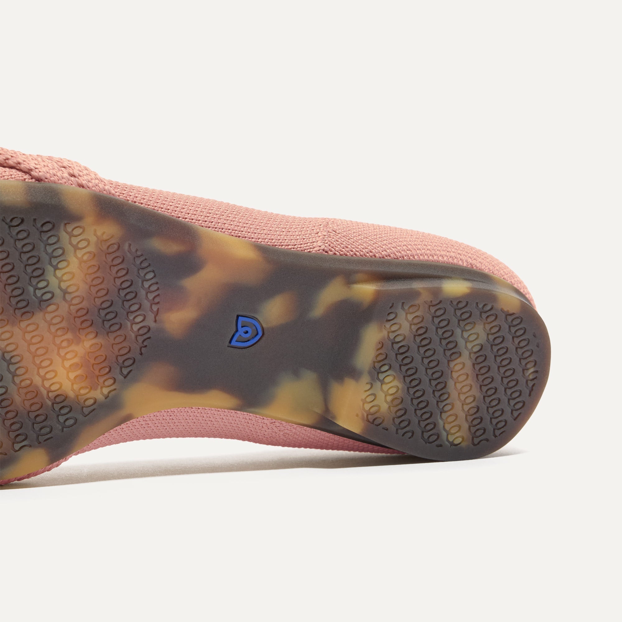 The sole of The Knot Ballet Flat in Peony shown in diagonal view.