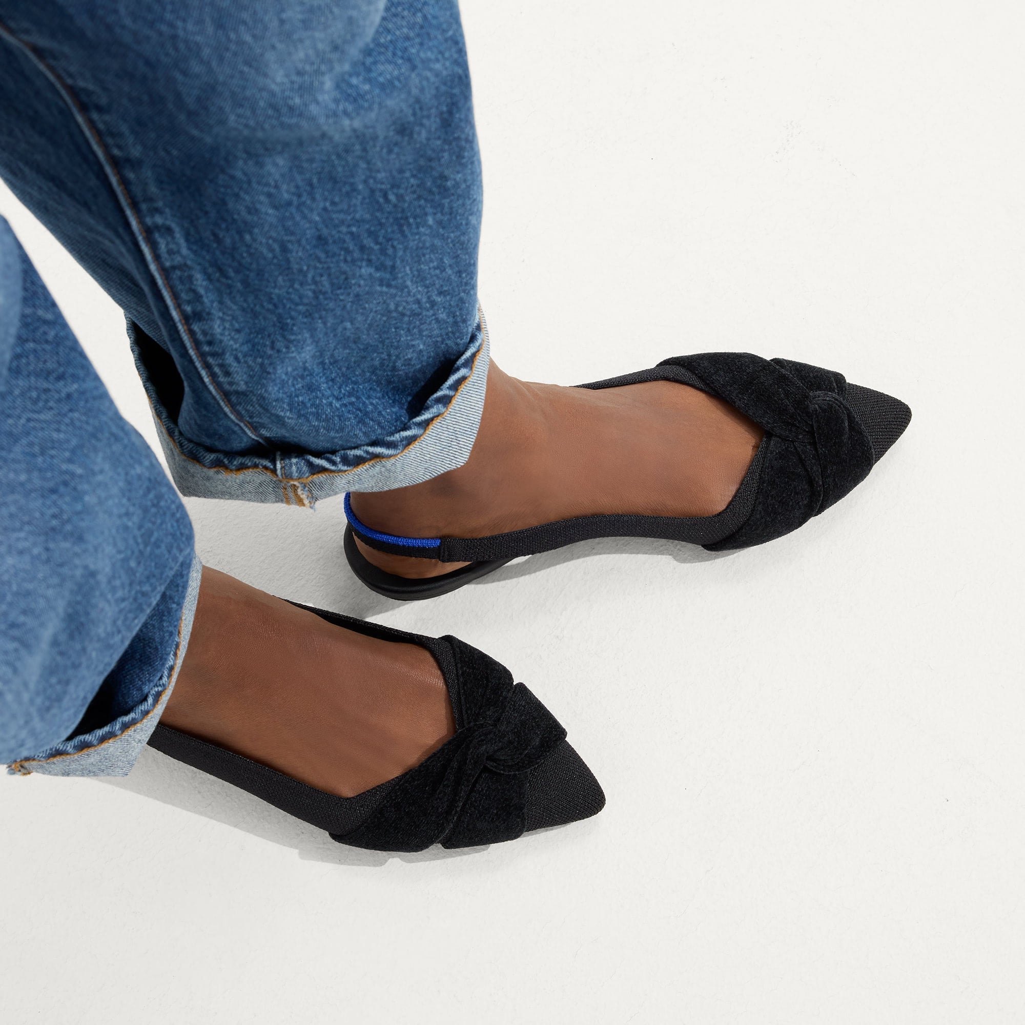 hover | Model wearing The Twist Point Slingback in Black.