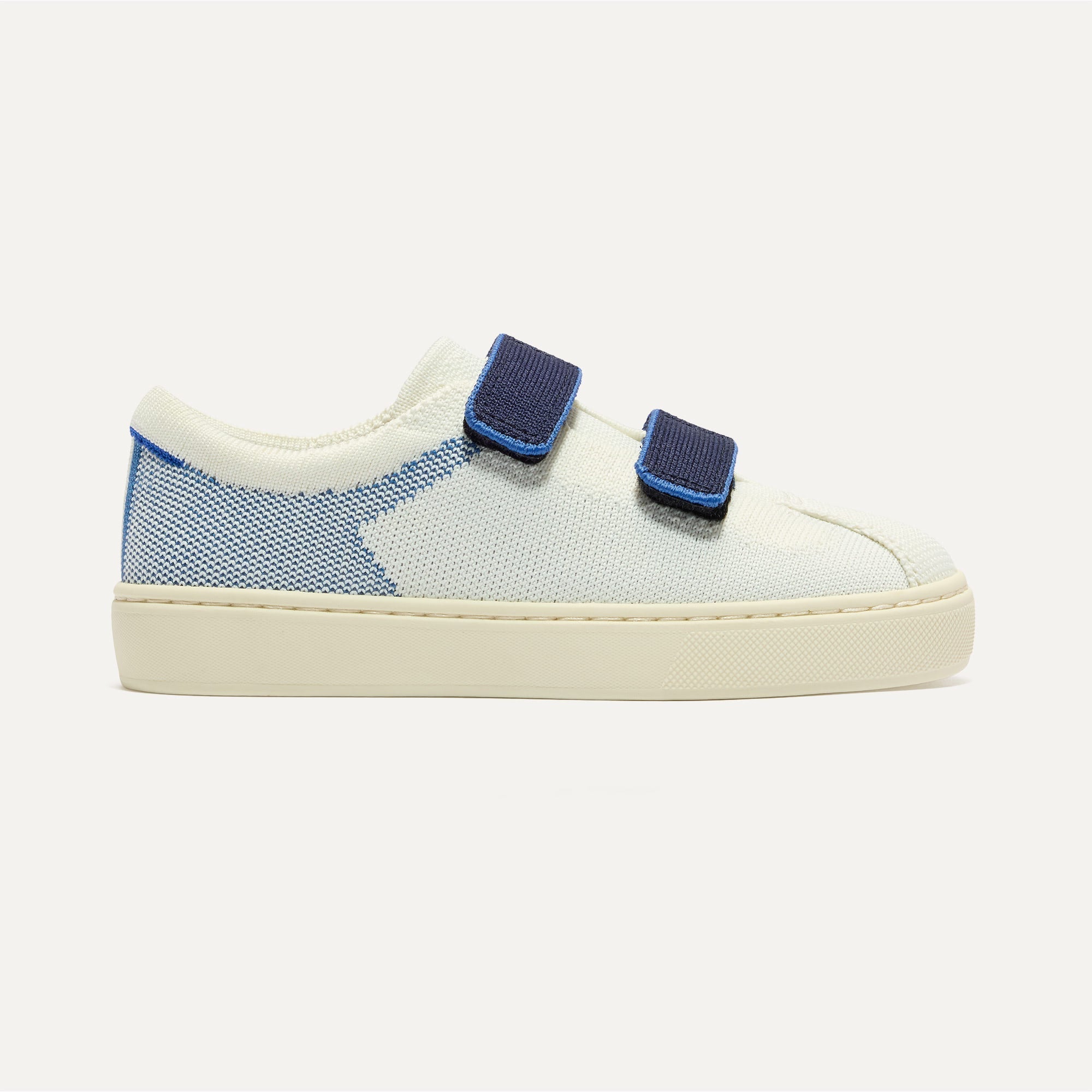 The Kids Strap Sneaker in Blue Raspberry shown from the side.