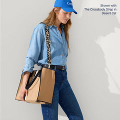 The Classic Tote in Grand Piano, worn as a crossbody by a model, shown from the side.