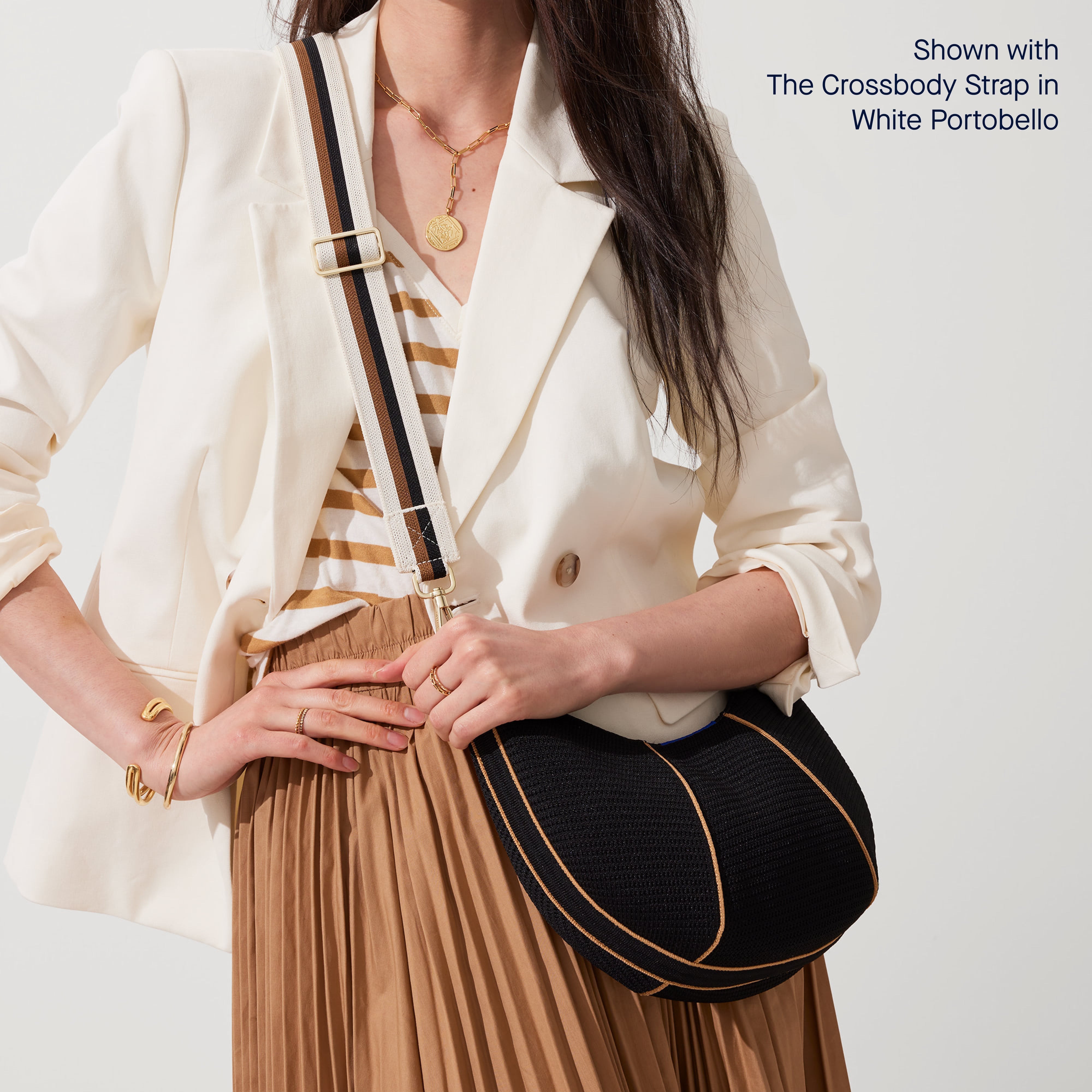 Model wearing The Crescent Bag in Black as a crossbody, shown with The Crossbody Strap. 