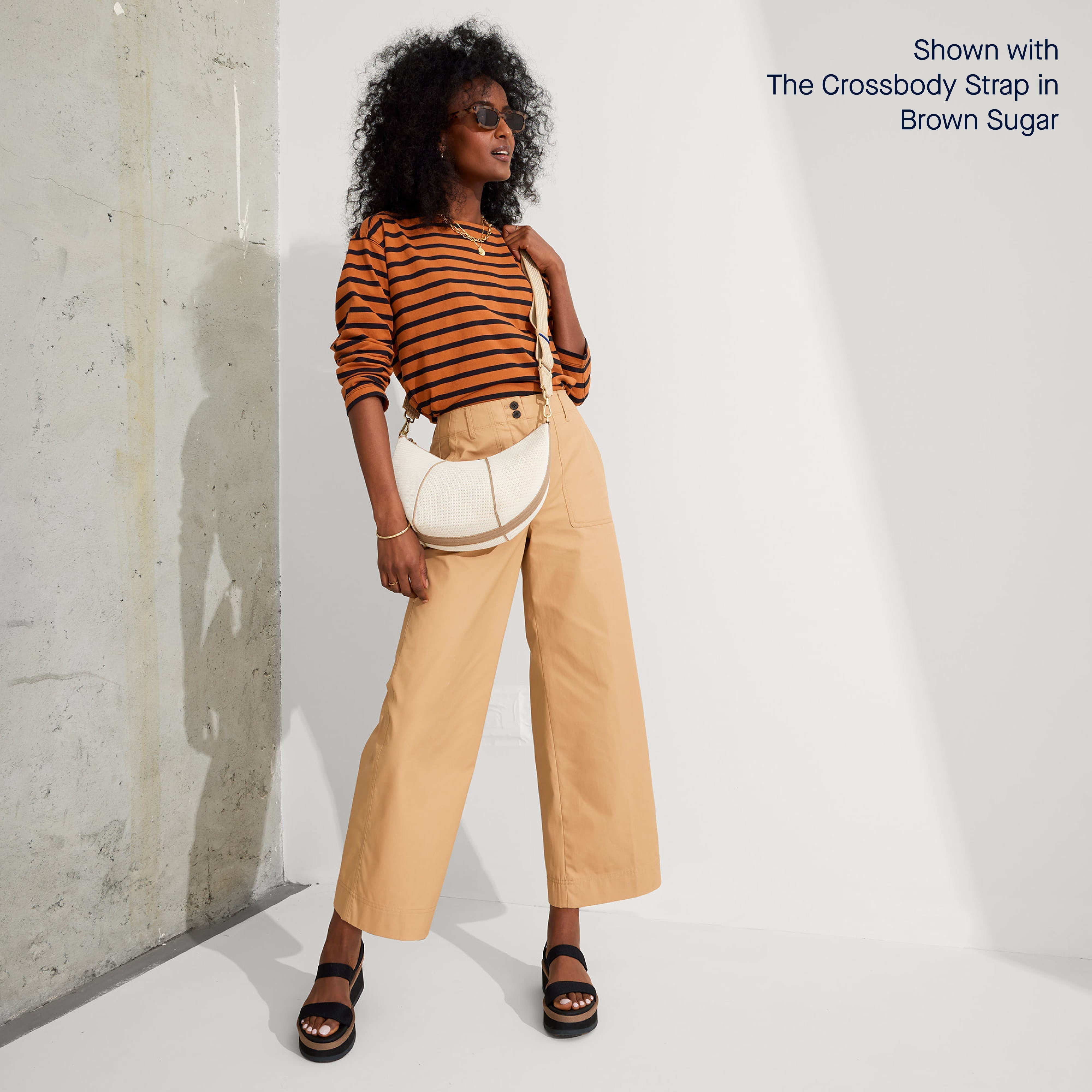Model wearing The Crescent Bag in Celestine as a crossbody, shown with The Crossbody Strap. 